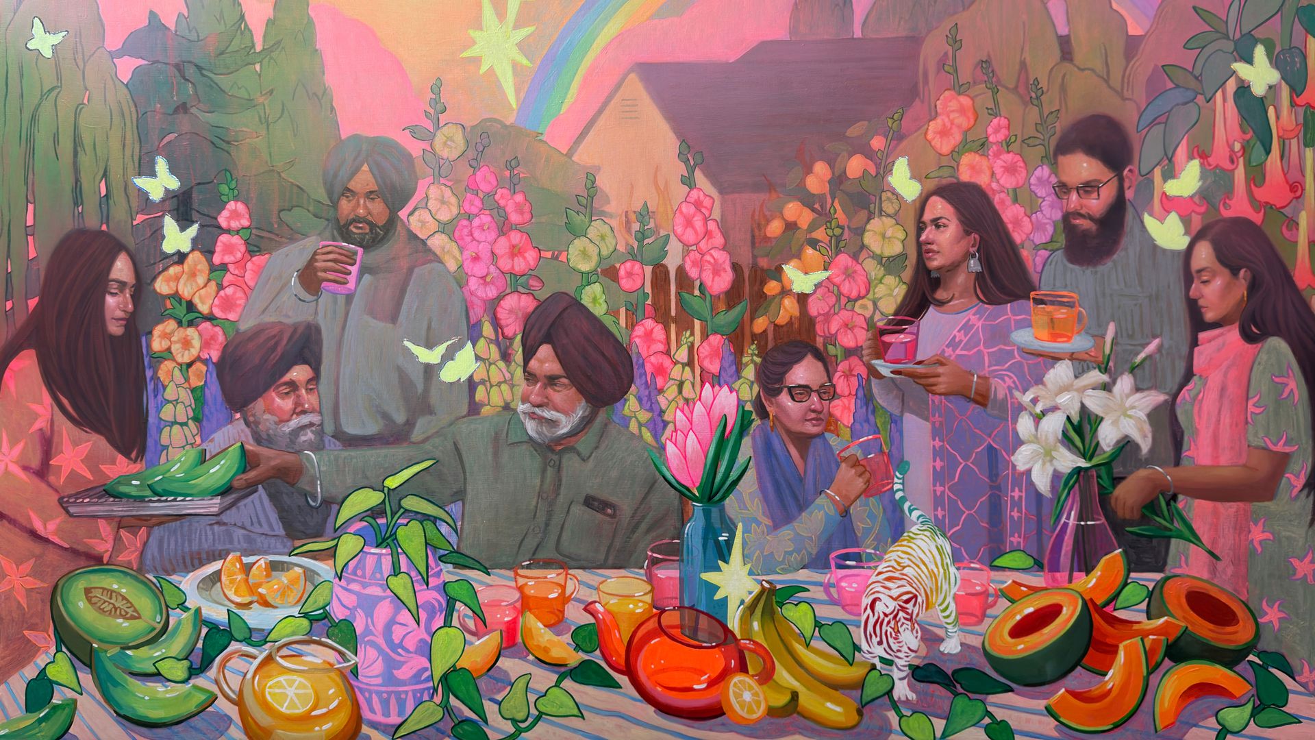 Colorful mural of people around a table with fruit, flowers, and drinks; butterflies flutter among plants, a rainbow arches across a pink sky with distant mountains.