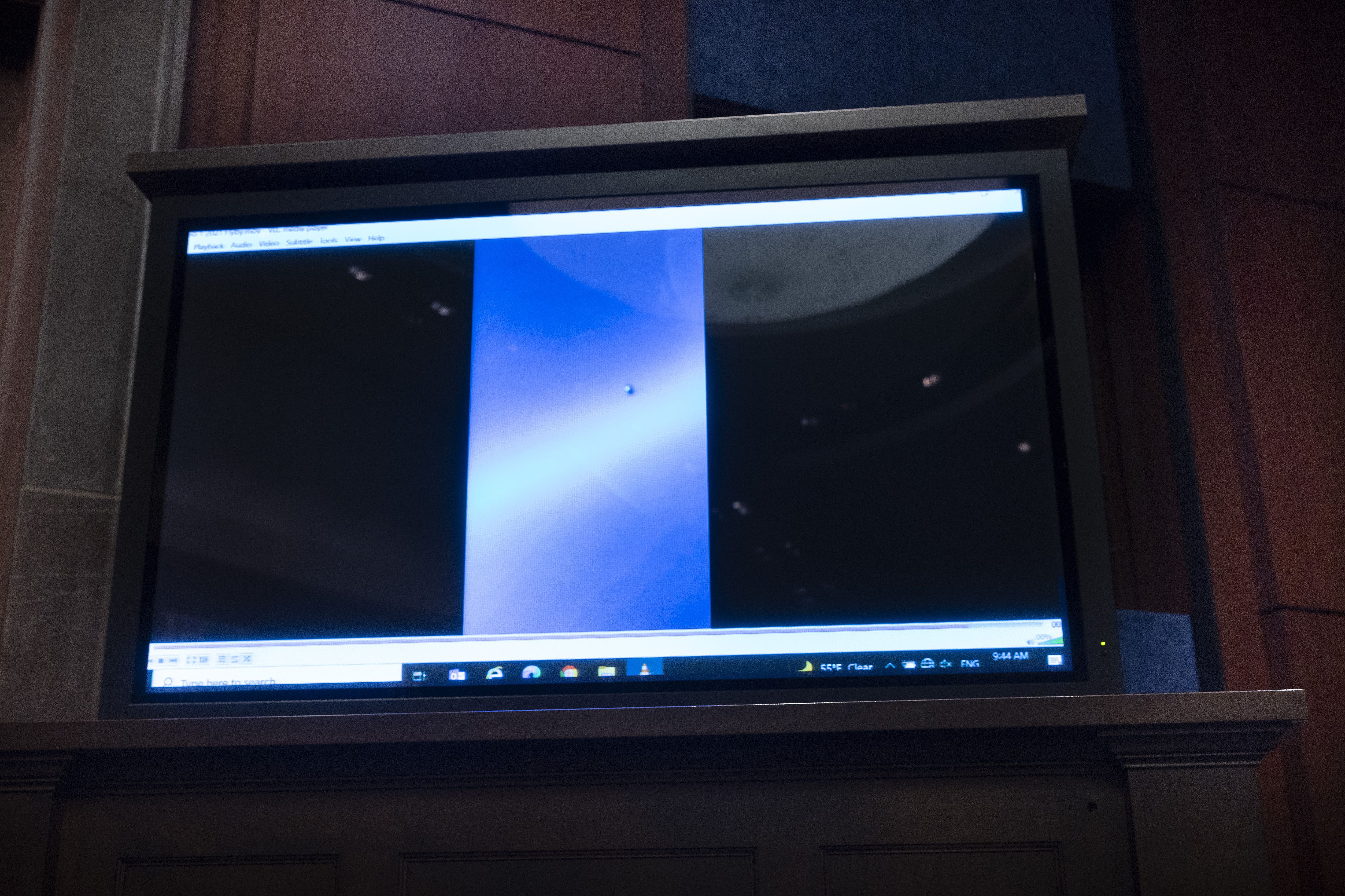 A video of unidentified aerial phenomena plays during a House Intelligence subcommittee hearing in 2022. 