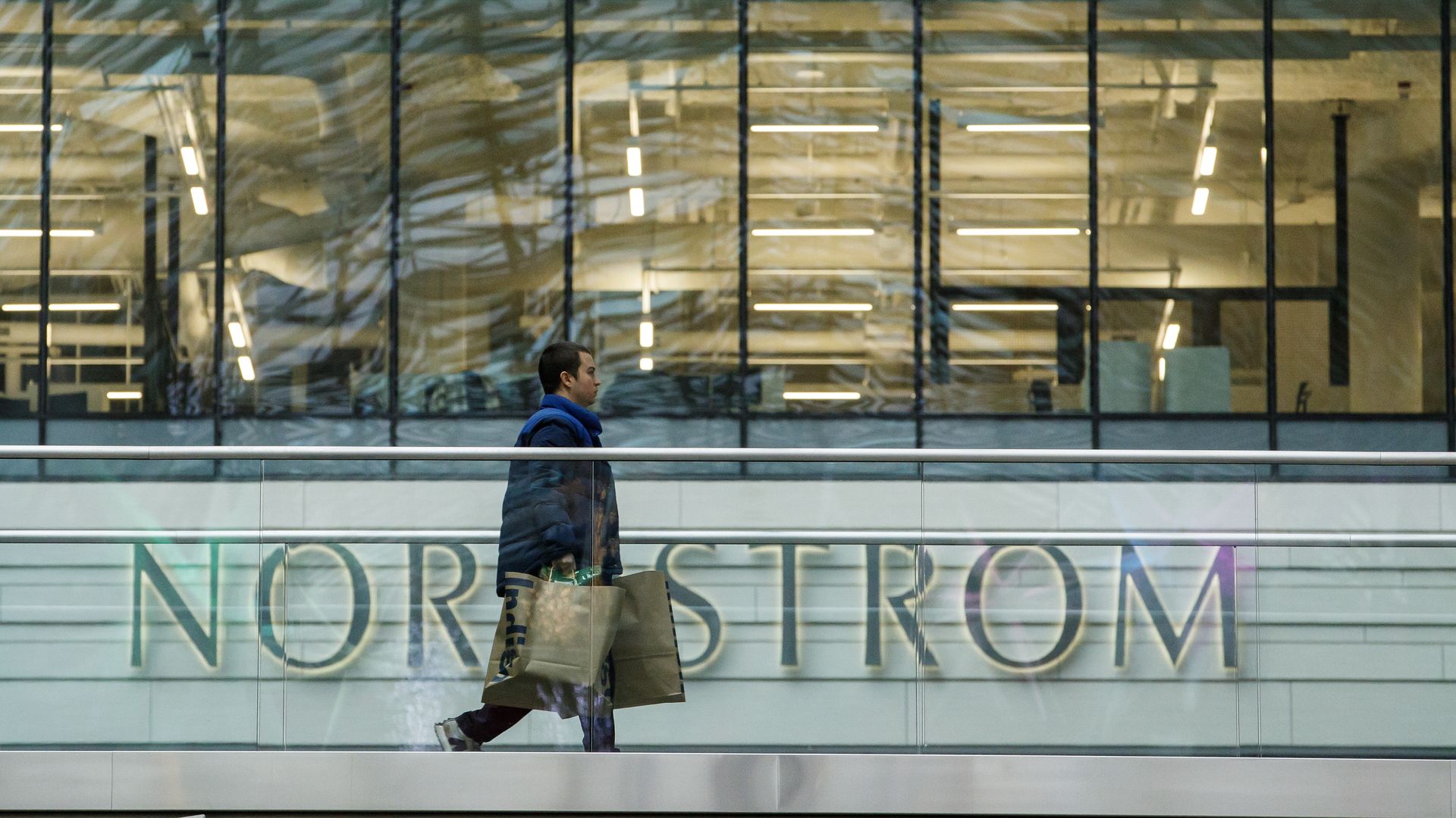 Image of shopper in front of Nordstrom storefront