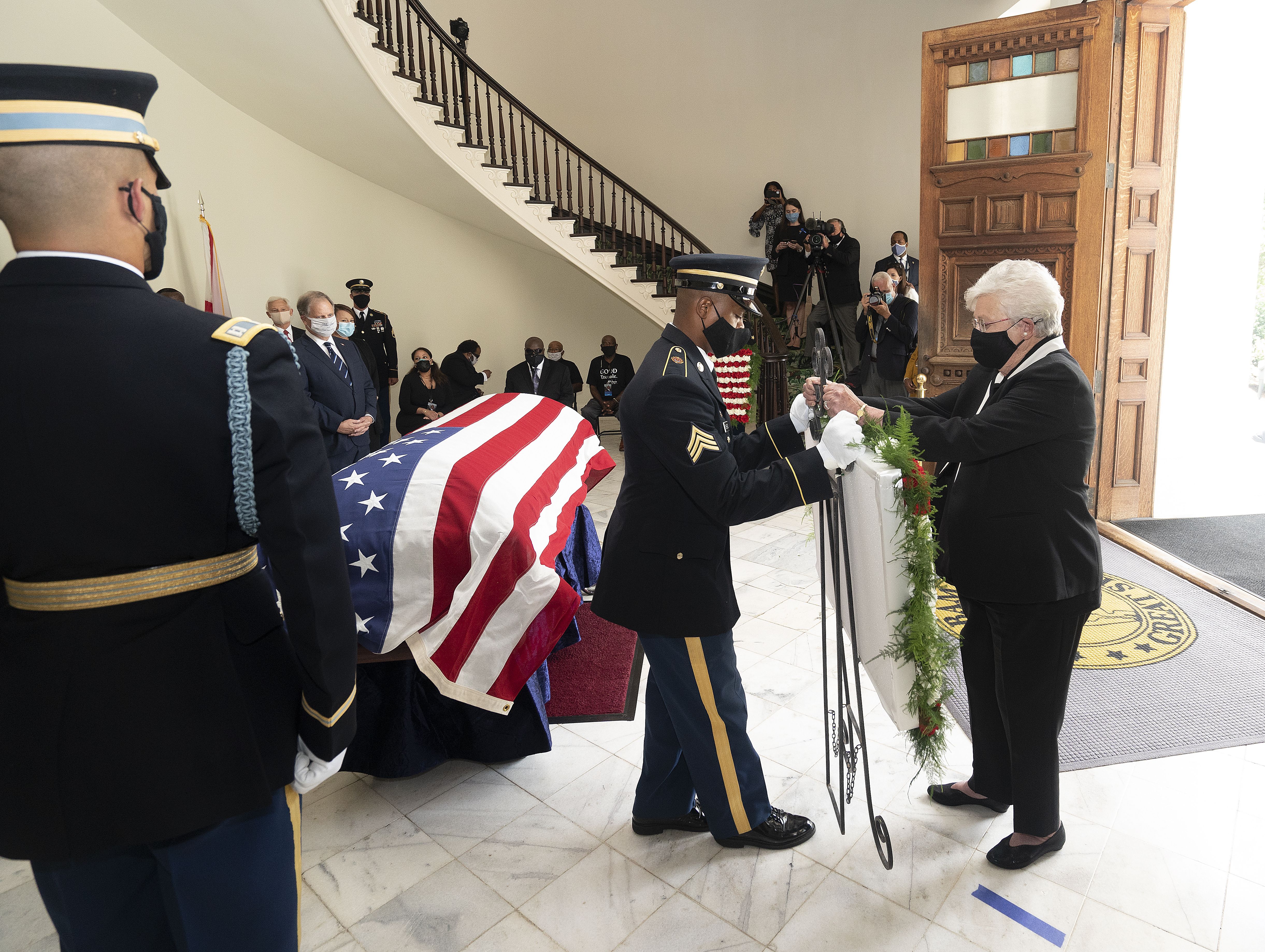  Gov. Kay Ivey places a wreath at the casket bearing the remains of John Lewis (D-GA) in the state Capitol building where he will lie in state on July 26, 2020 in Montgomery, Alabama. 
