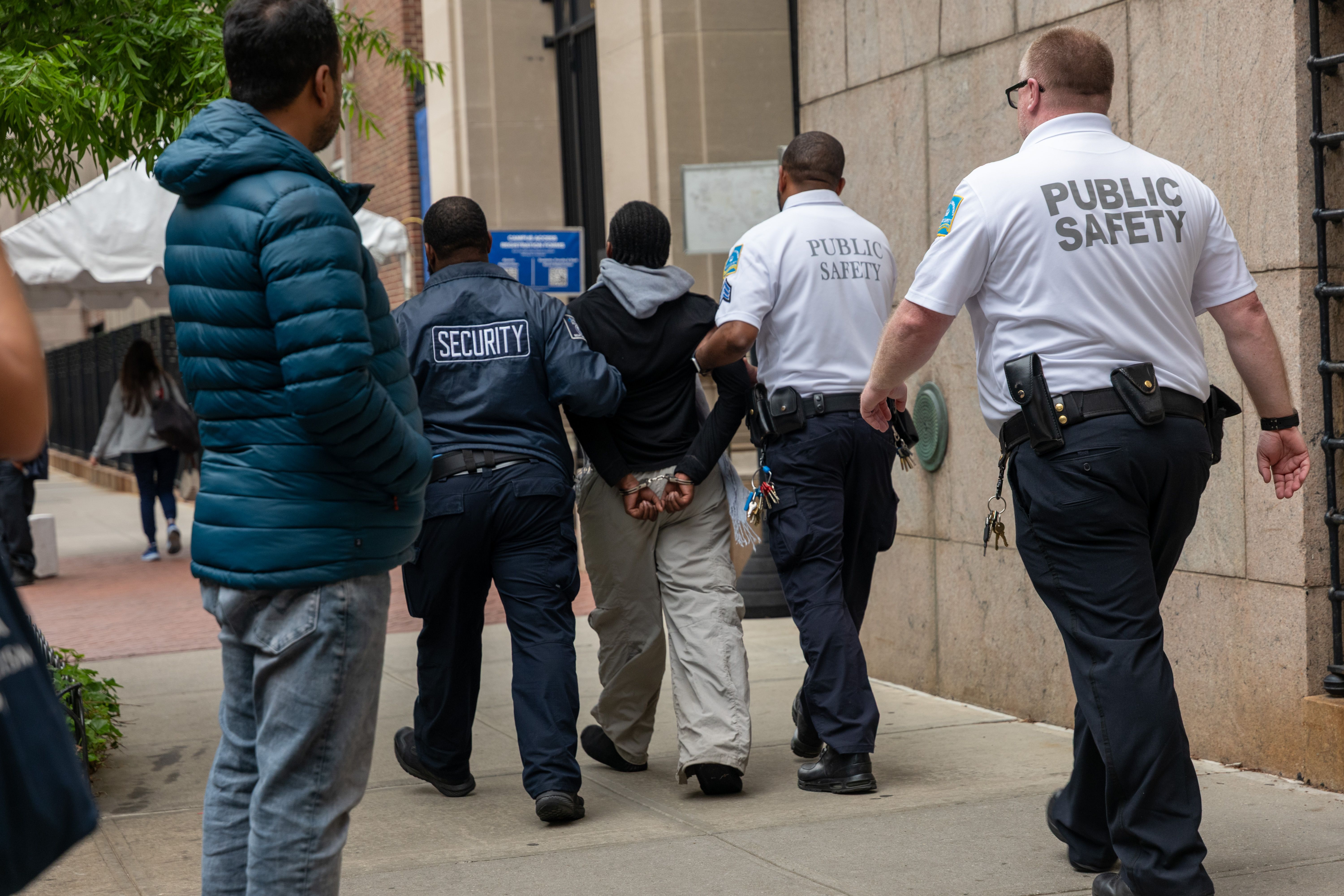 NEW YORK, NEW YORK - MAY 07: A person is detained outside of Columbia University's Butler Library after pro-Palestinian protesters occupied the space on May 07, 2025 in New York City. Crowds of protesters grew as a standoff with security and group calling themselves "Columbia University Apartheid Di
