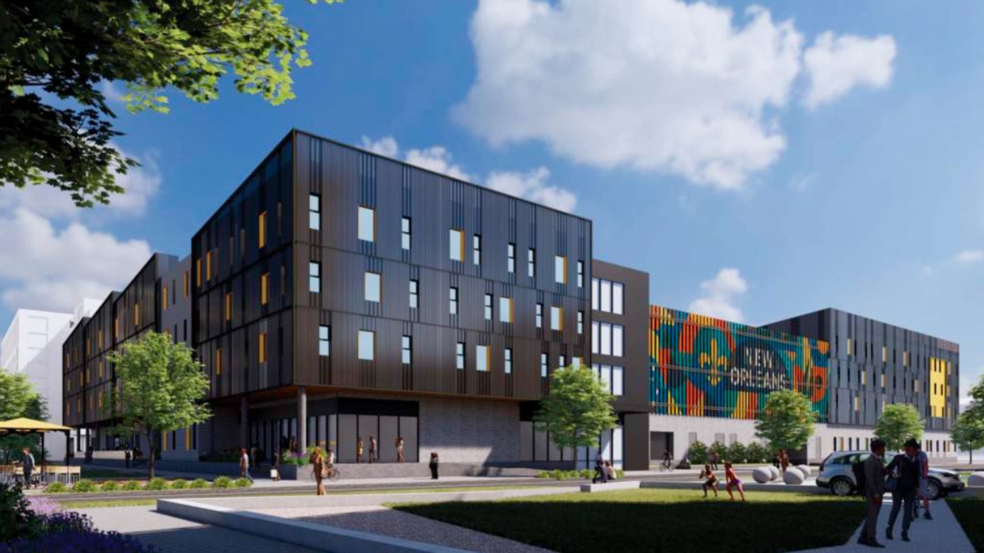 Rendering of a modern black and gray building with yellow window accents and a colorful mural reading "New Orleans" under a blue sky, surrounded by trees and people walking nearby.