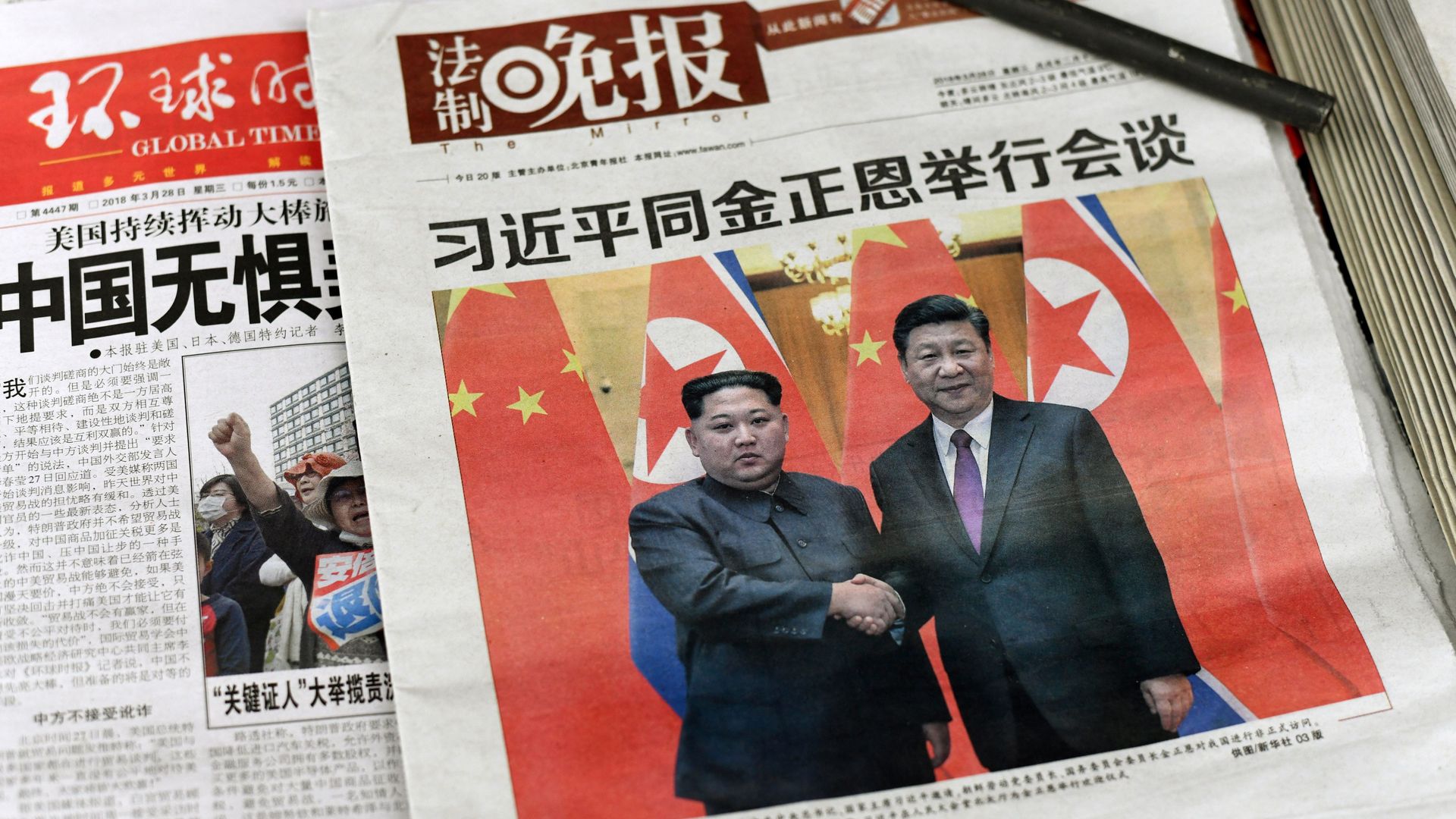 Chinese newspapers with photo of Xi Jinping and Kim Jong-un on cover