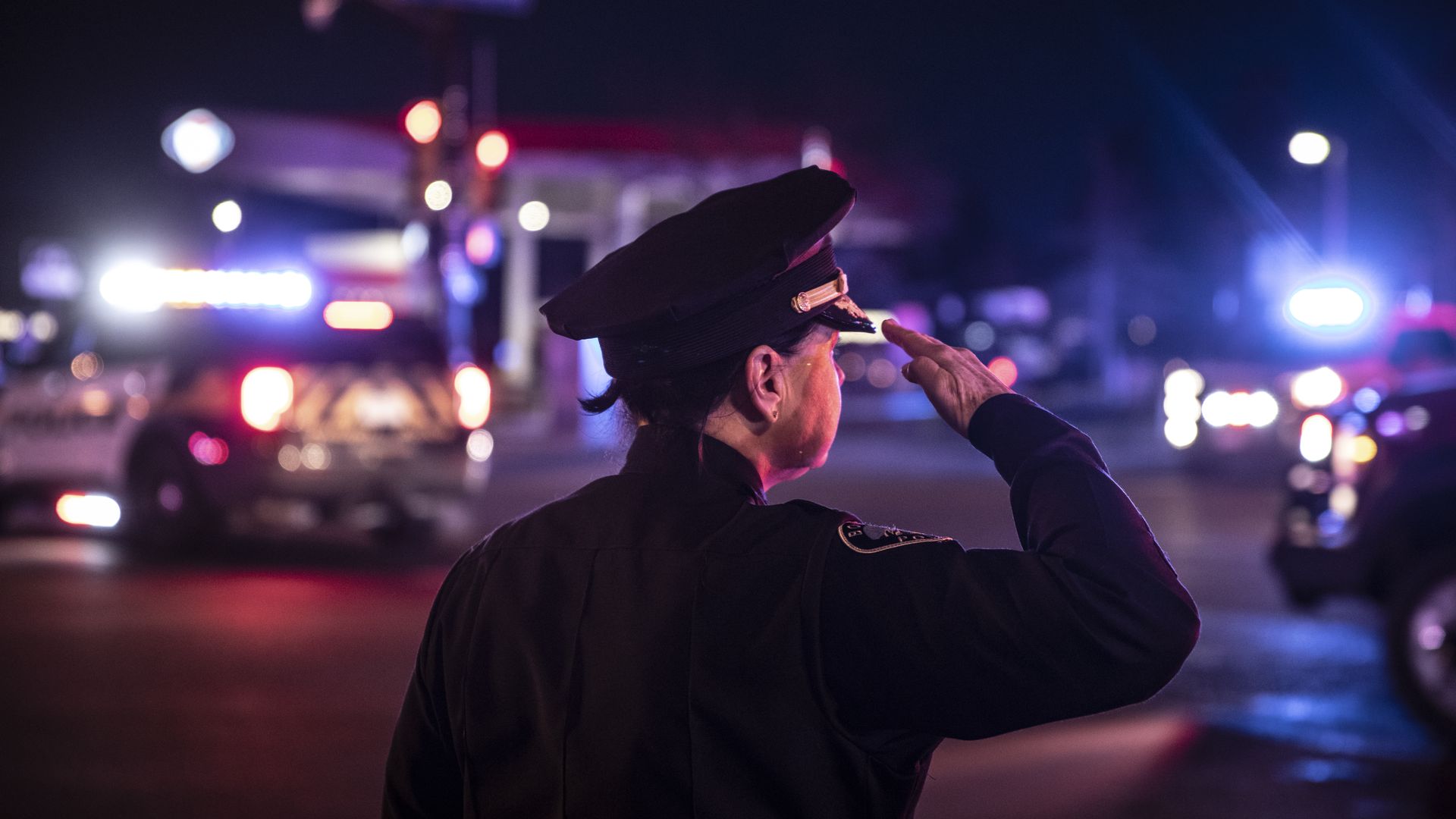 A photo of a police officer doing a salute.