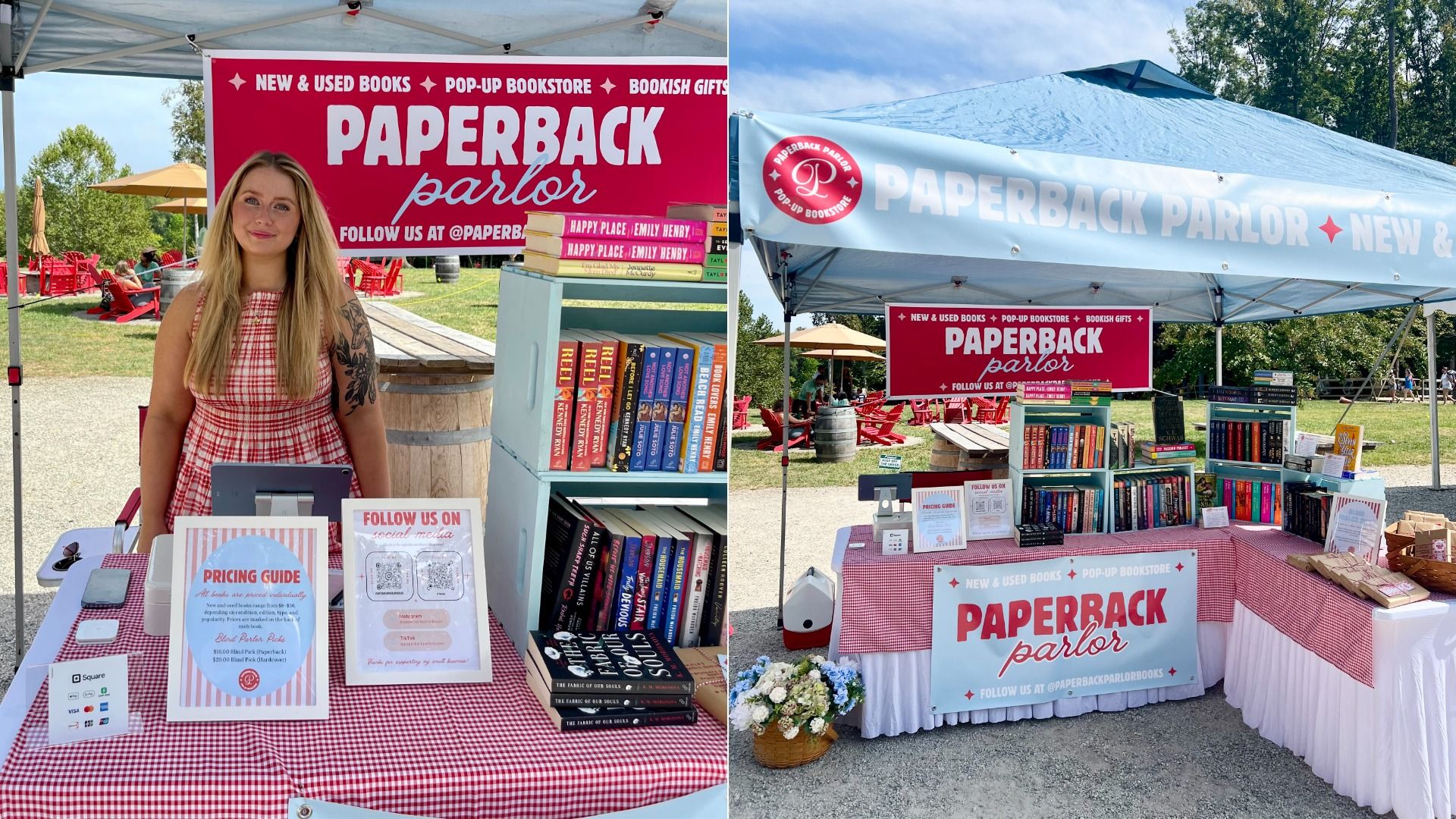 Outdoor book booth named "Paperback Parlor" under a blue canopy. A smiling blonde woman in a red gingham dress stands beside stacks of colorful books, with pink banners promoting new and used titles.