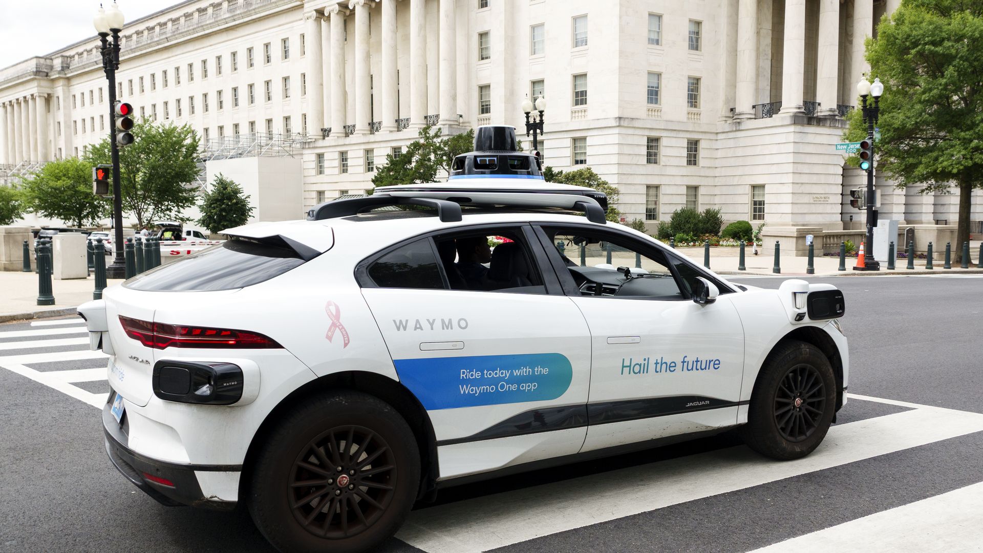 A Waymo robotaxi testing on a downtown D.C. street