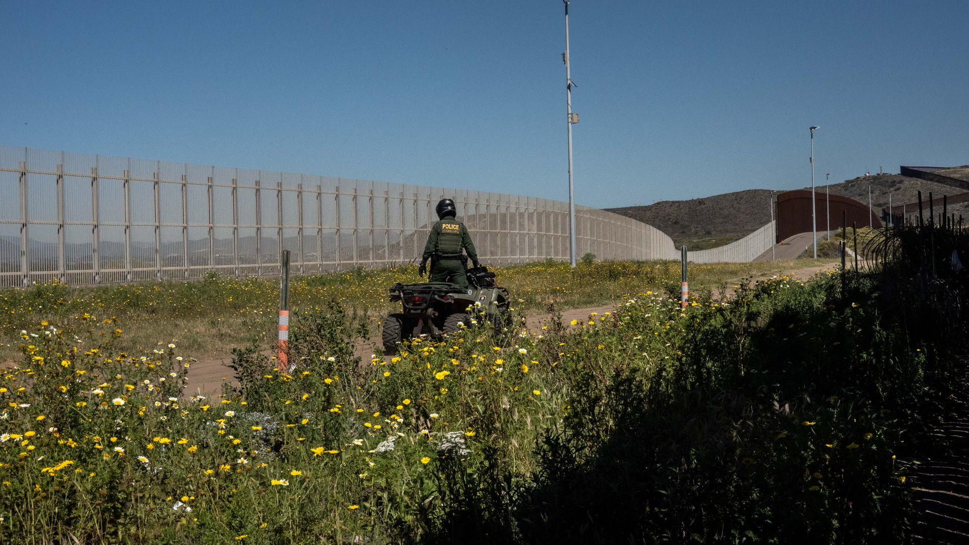A U.S. law enforcement officer patrols a section of the U.S. and Mexico border fence in Tijuana, Mexico, on Wednesday, March 23, 2022