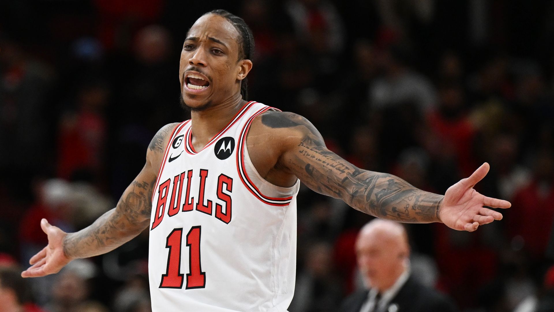 Photo of a basketball player stretching out his arms. 