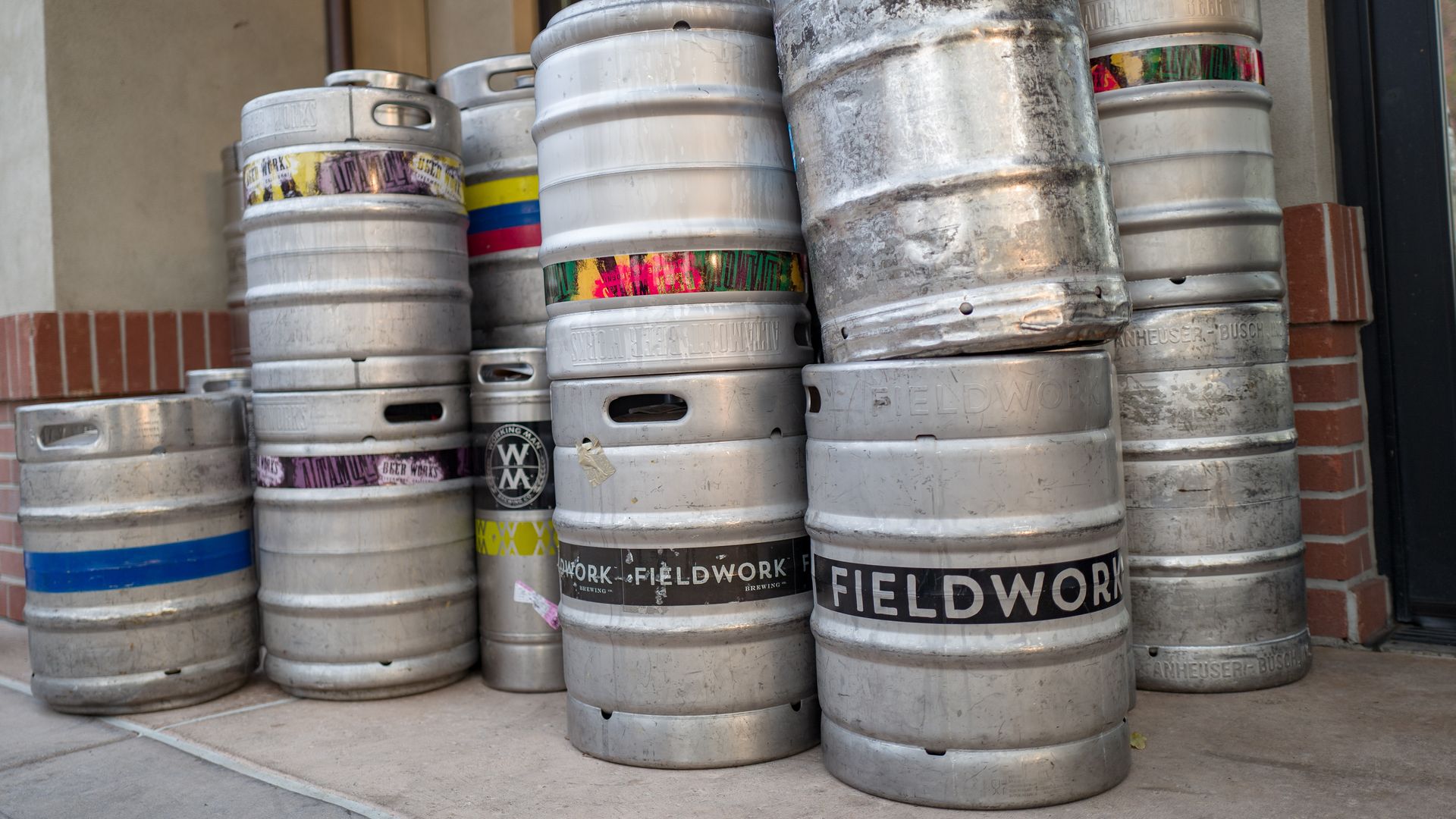 Low-angle view of stack of kegs containing craft brew beer from microbreweries