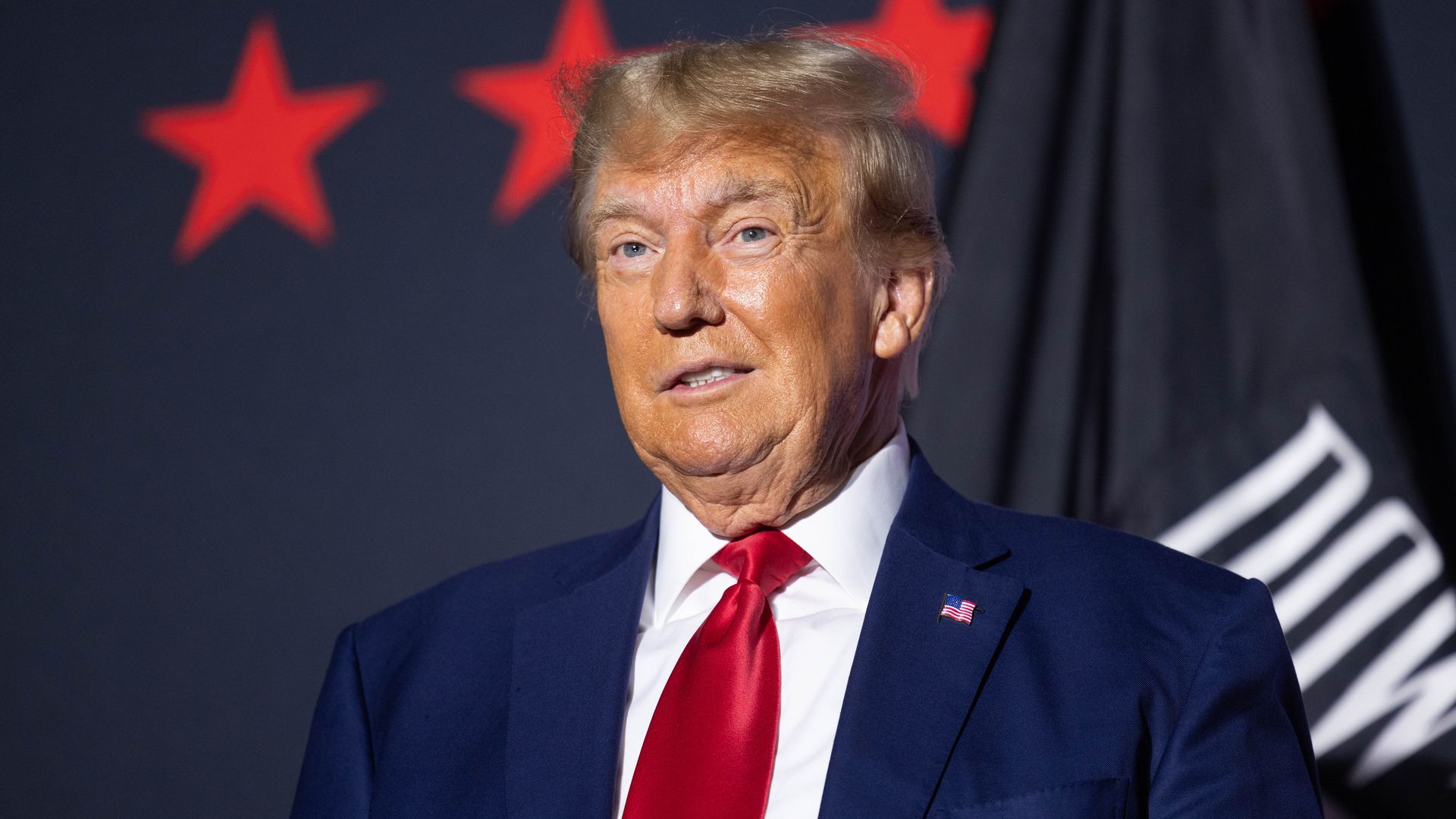 Former U.S. President Donald Trump on stage before delivering remarks at Windham High School on August 8, 2023 in Windham, New Hampshire. This is the fourth visit that former President Trump has made to New Hampshire this campaign season.