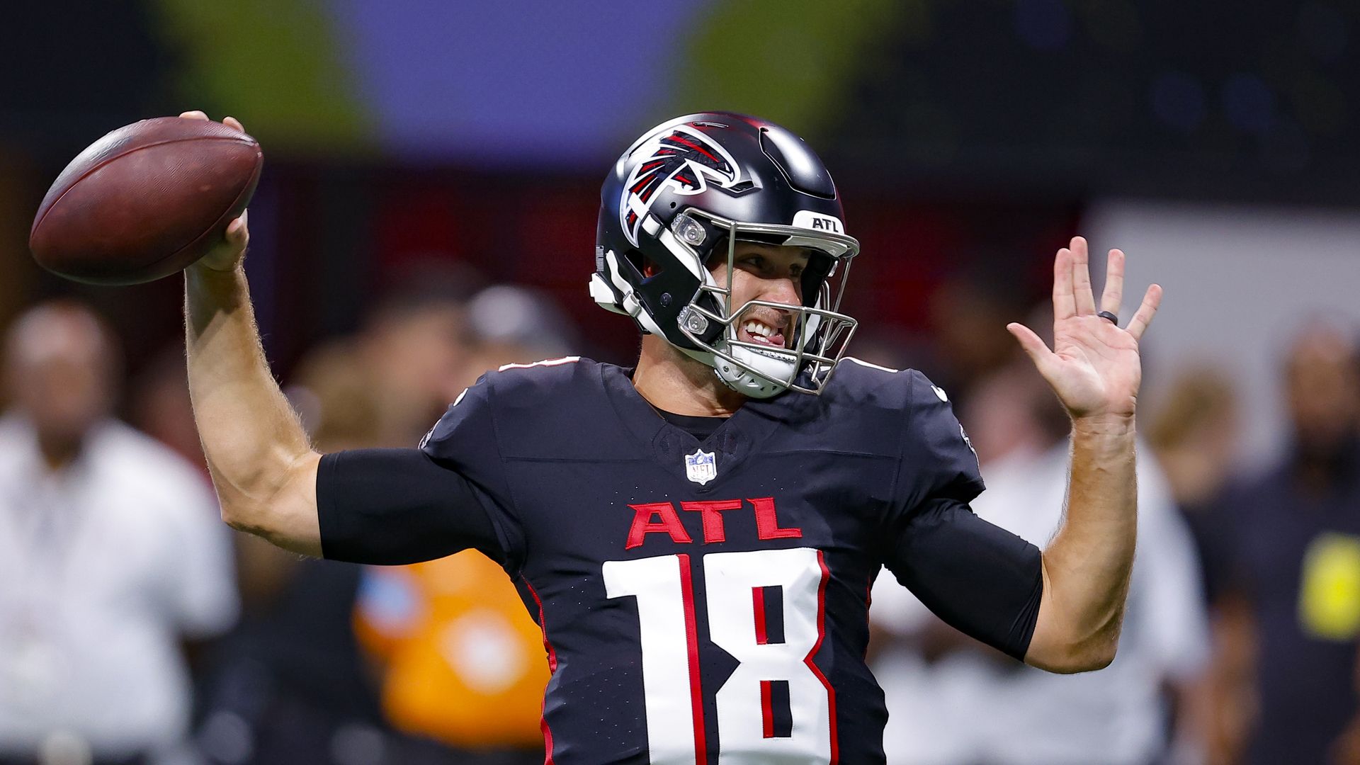 Kirk Cousins in a black Atlanta uniform wearing number 18