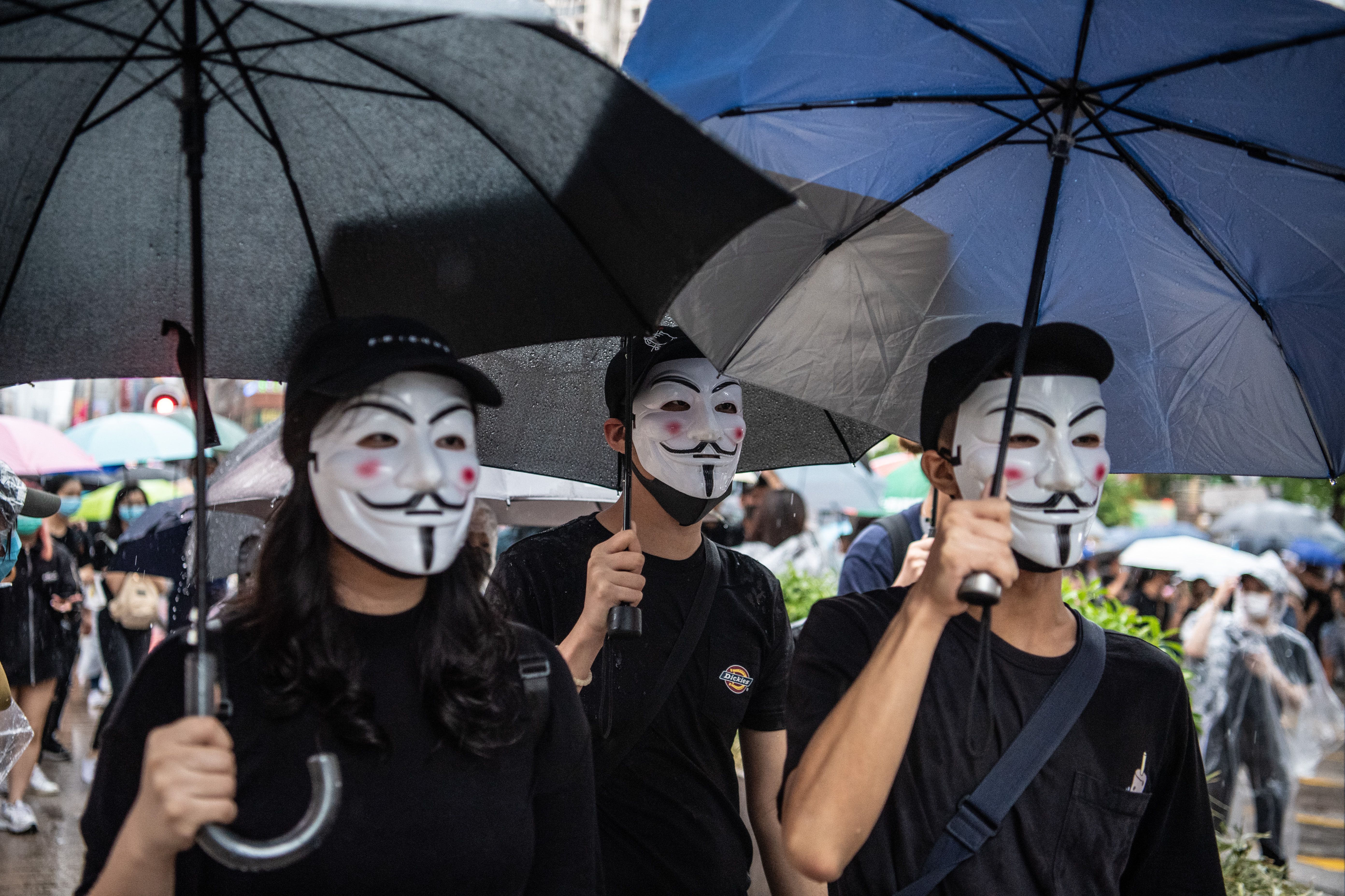 Protestors don Guy Fawkes masks in Kowloon