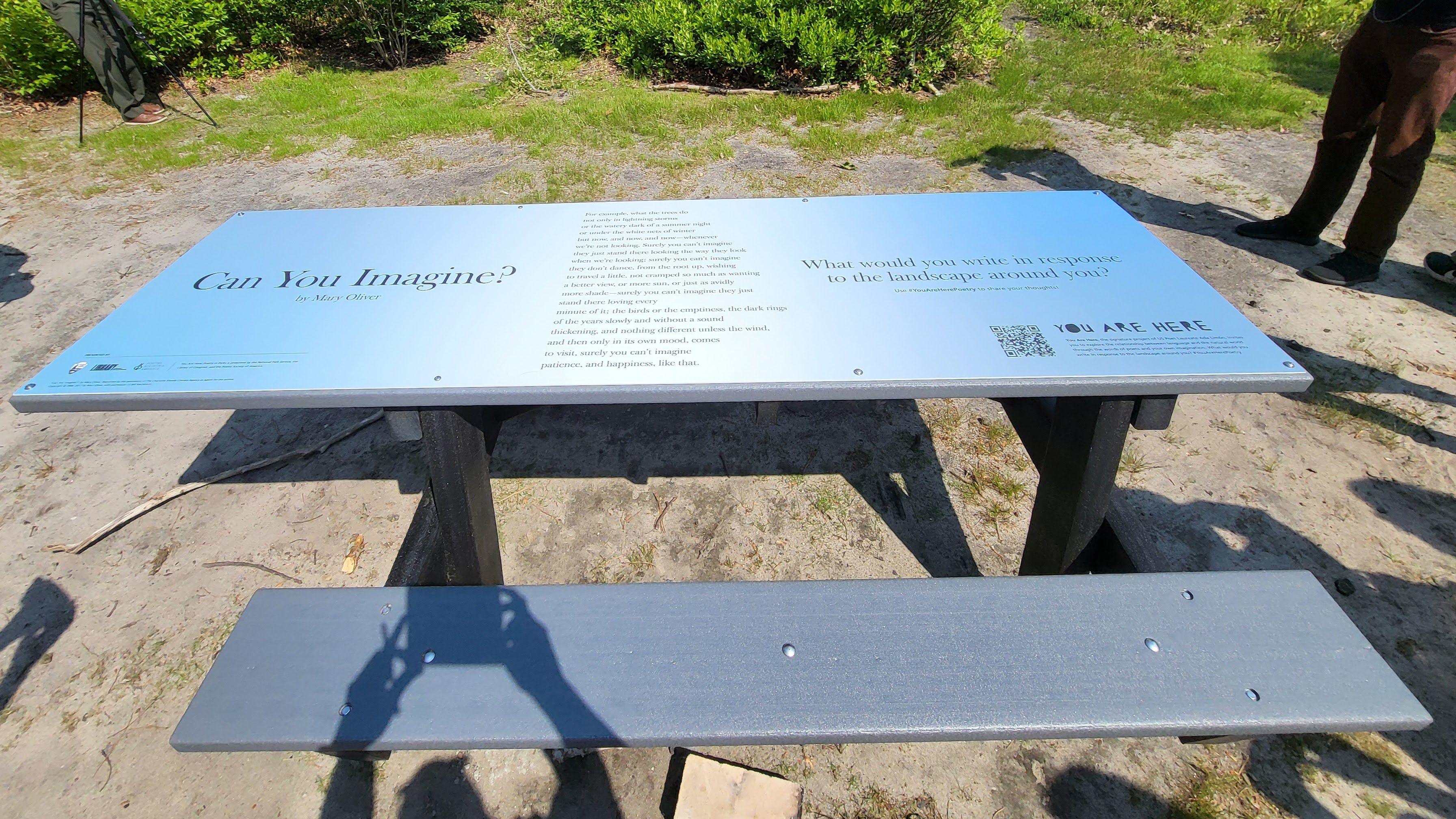 a picnic table with a poem printed on it