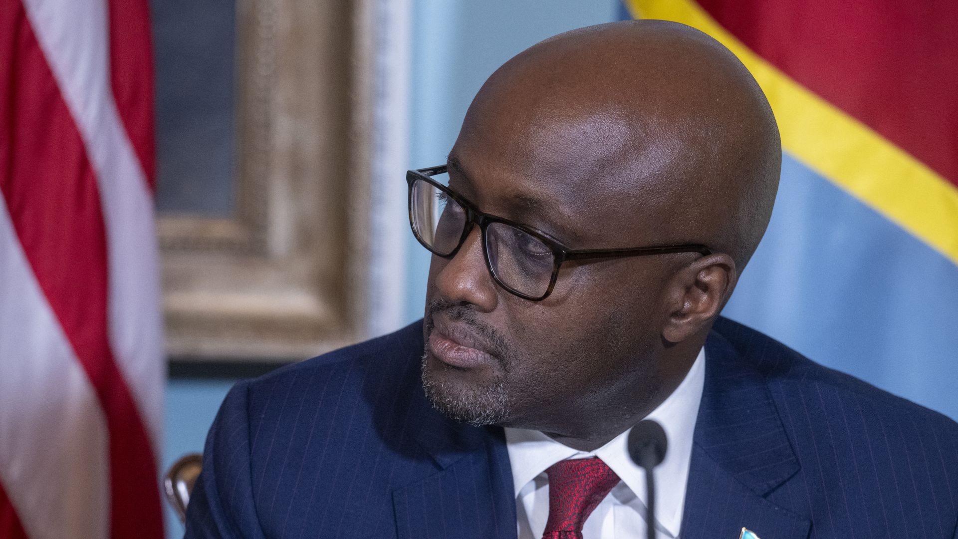 Rwandan Foreign Minister Olivier Nduhungirehe listens and looks on during a ceremony.