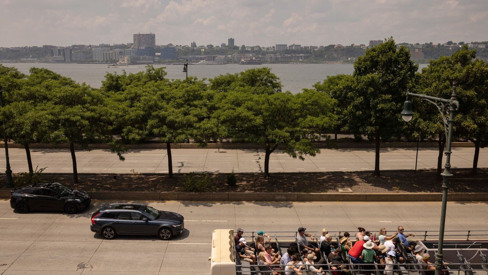 A Big Bus passed by the West Side Highway and Hudson River in New York. 