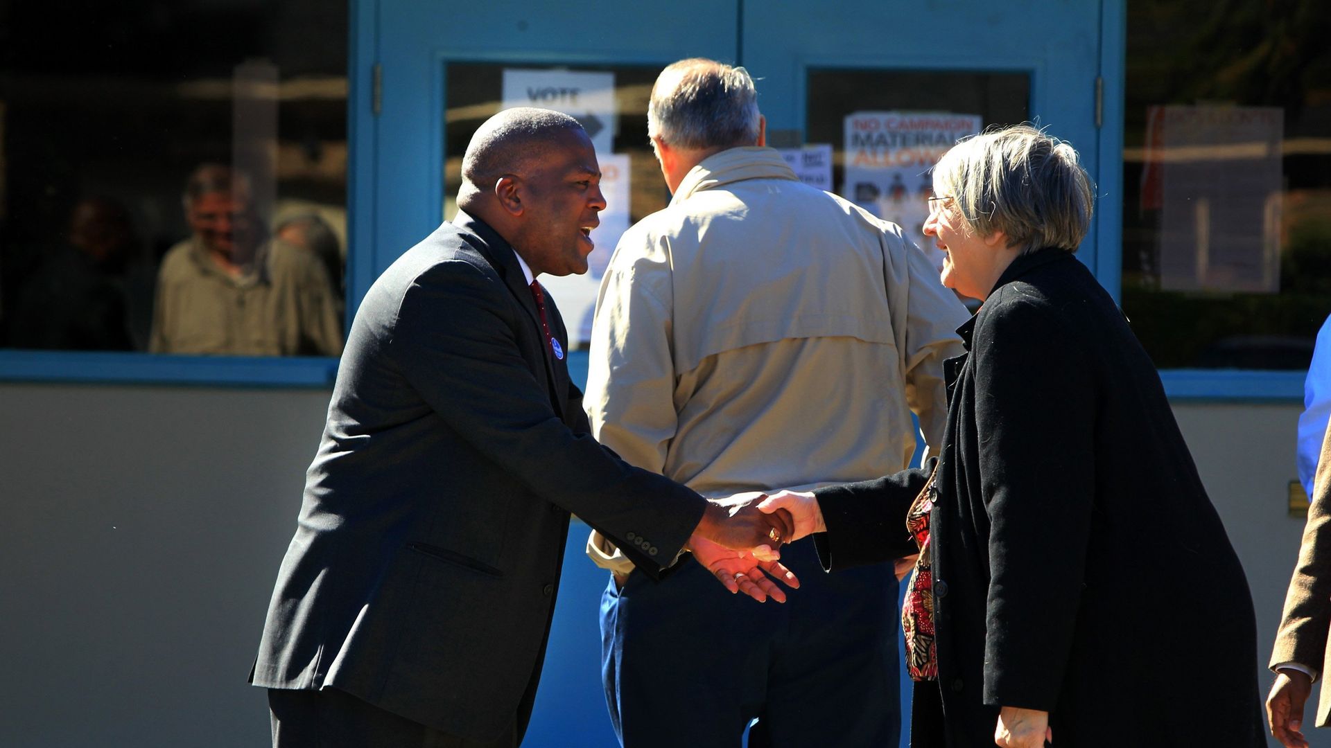 Mayor Steve Benjamin, left, greets voters outside Woodland Park in Columbia, South Carolina. 