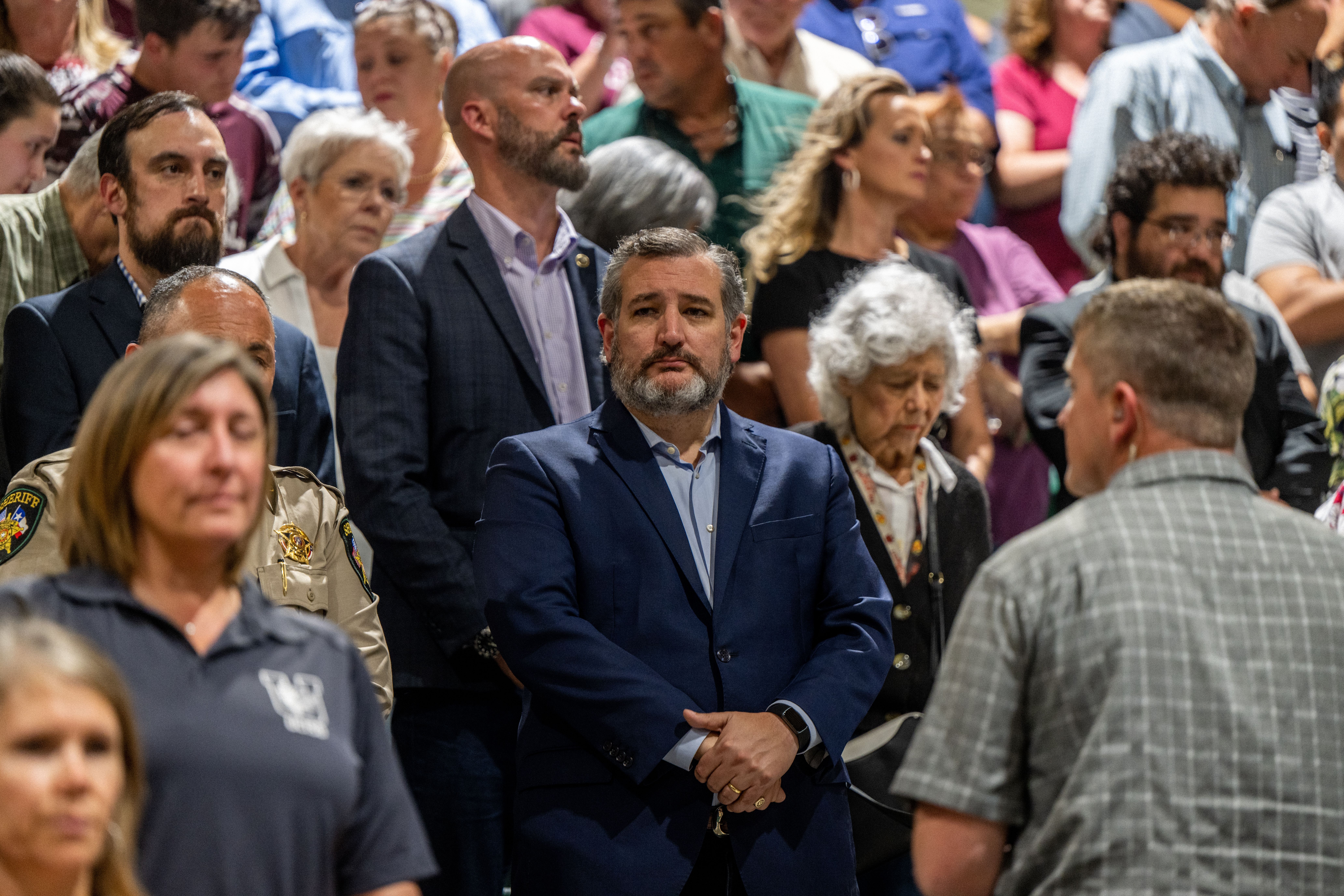 Sen. Ted Cruz listens during a prayer at a vigil for the 21 victims in the mass shooting at Rob Elementary School on May 25, 2022 in Uvalde, Texas. 