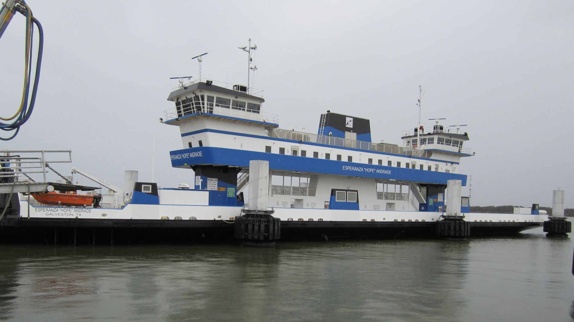 Photo of a blue and white ferry. 