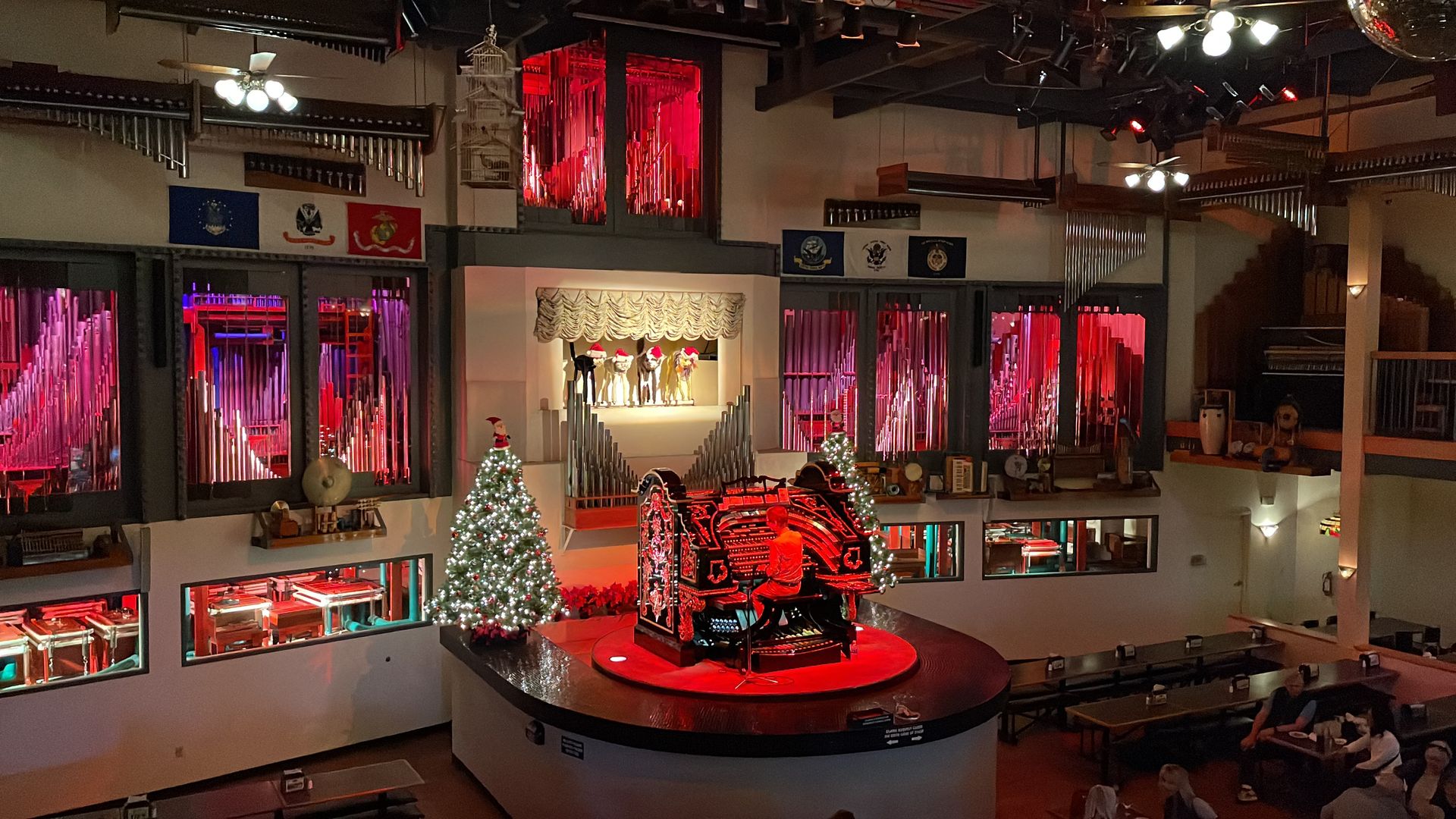 An organ on a stage decorated for Christmas.