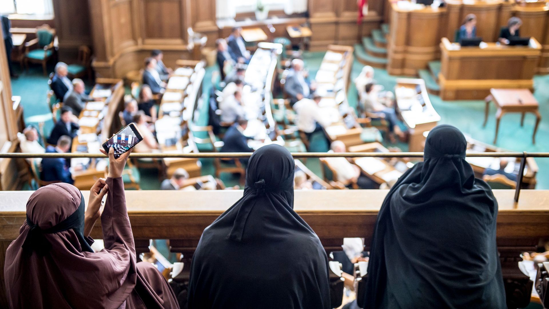 Women wearing niqab sit in the audience at the Danish Parliament in Copenhagen, Denmark. 