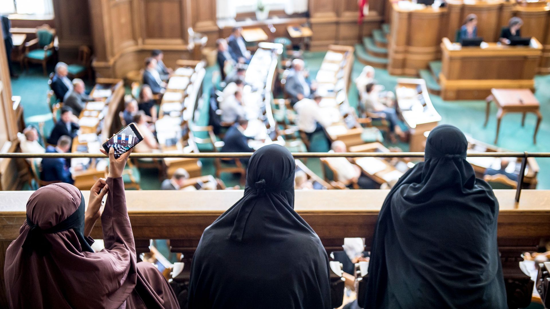 Women wearing niqab sit in the audience at the Danish Parliament in Copenhagen, Denmark.
