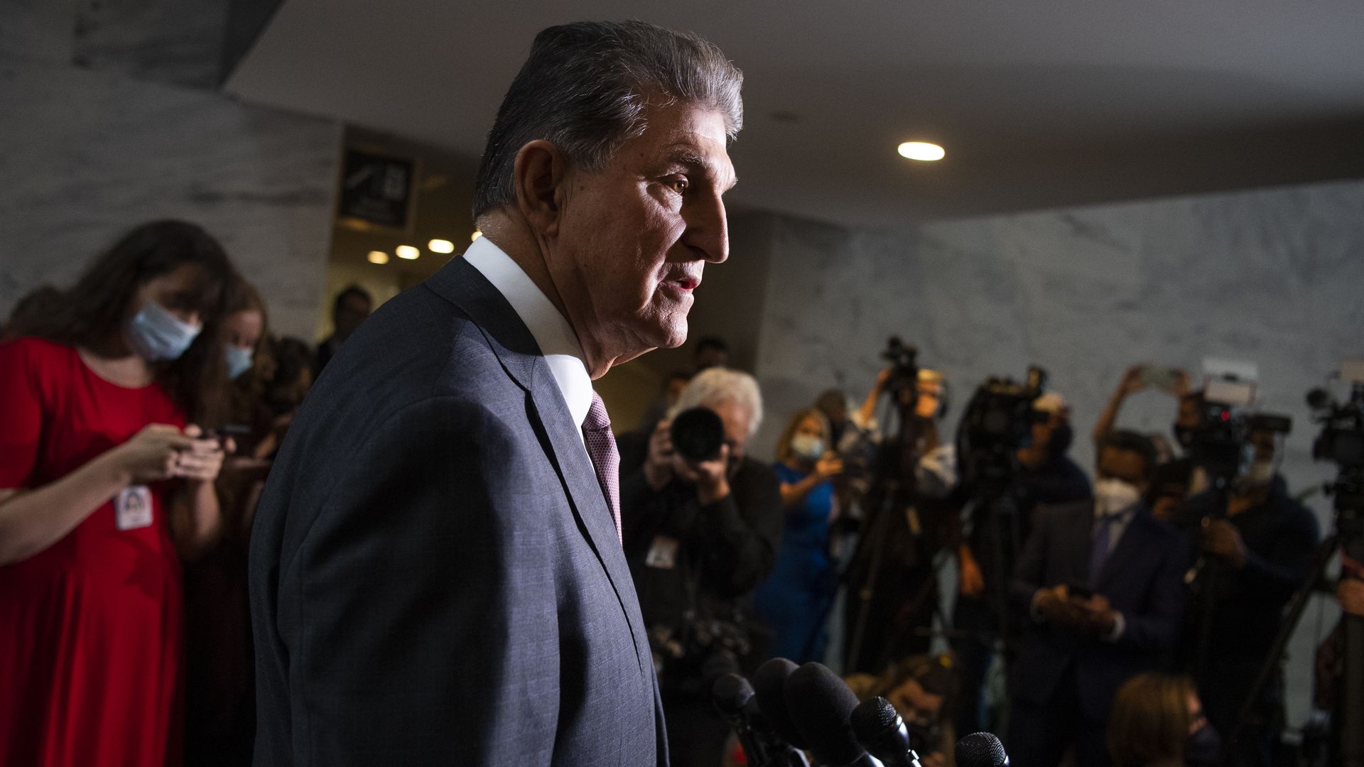 Photo of Joe Manchin speaking to a crowd of reporters