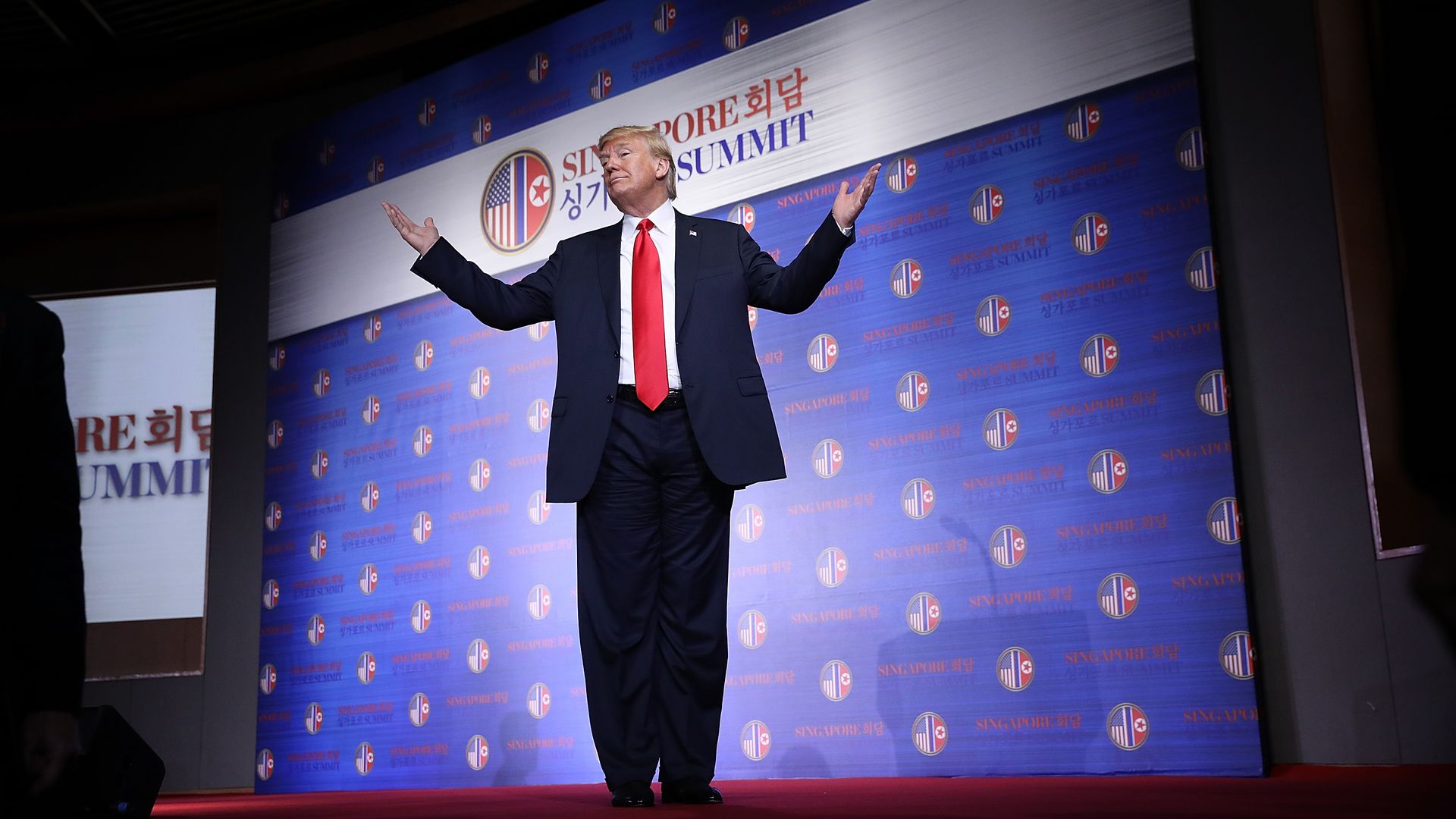 President Trump on stage with his hands in the air