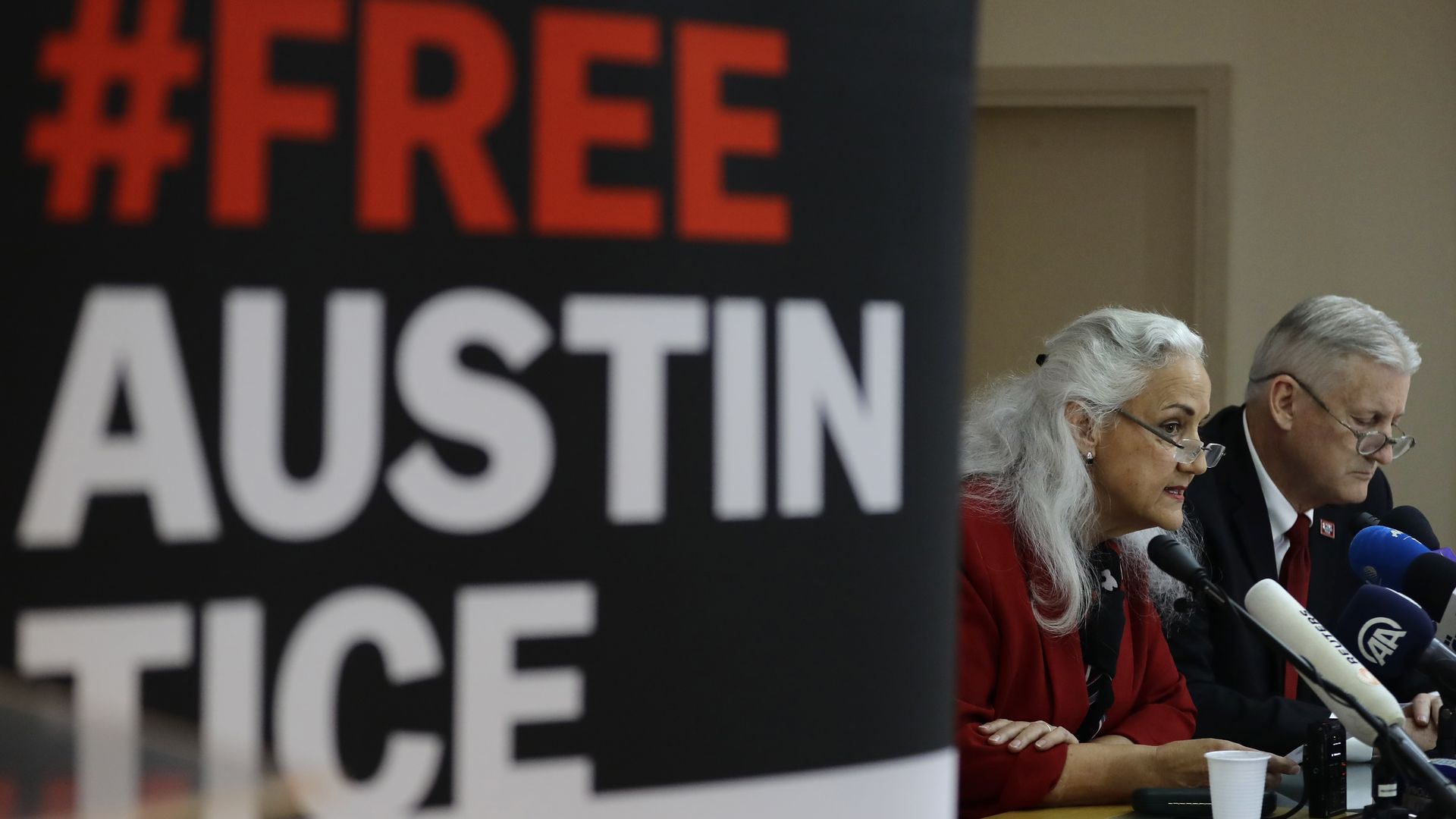 Austin Tice's parents next to "Free Austin Tice" sign