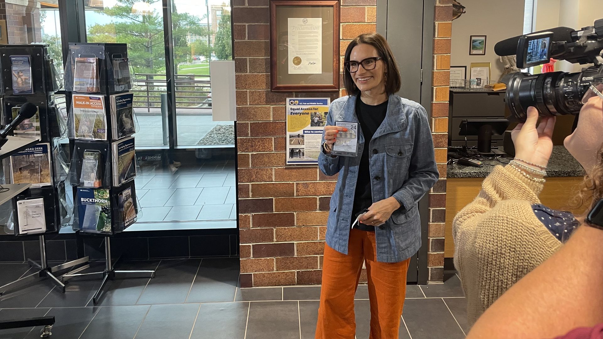 A photo of Peggy Flabagan holding a hunting license 