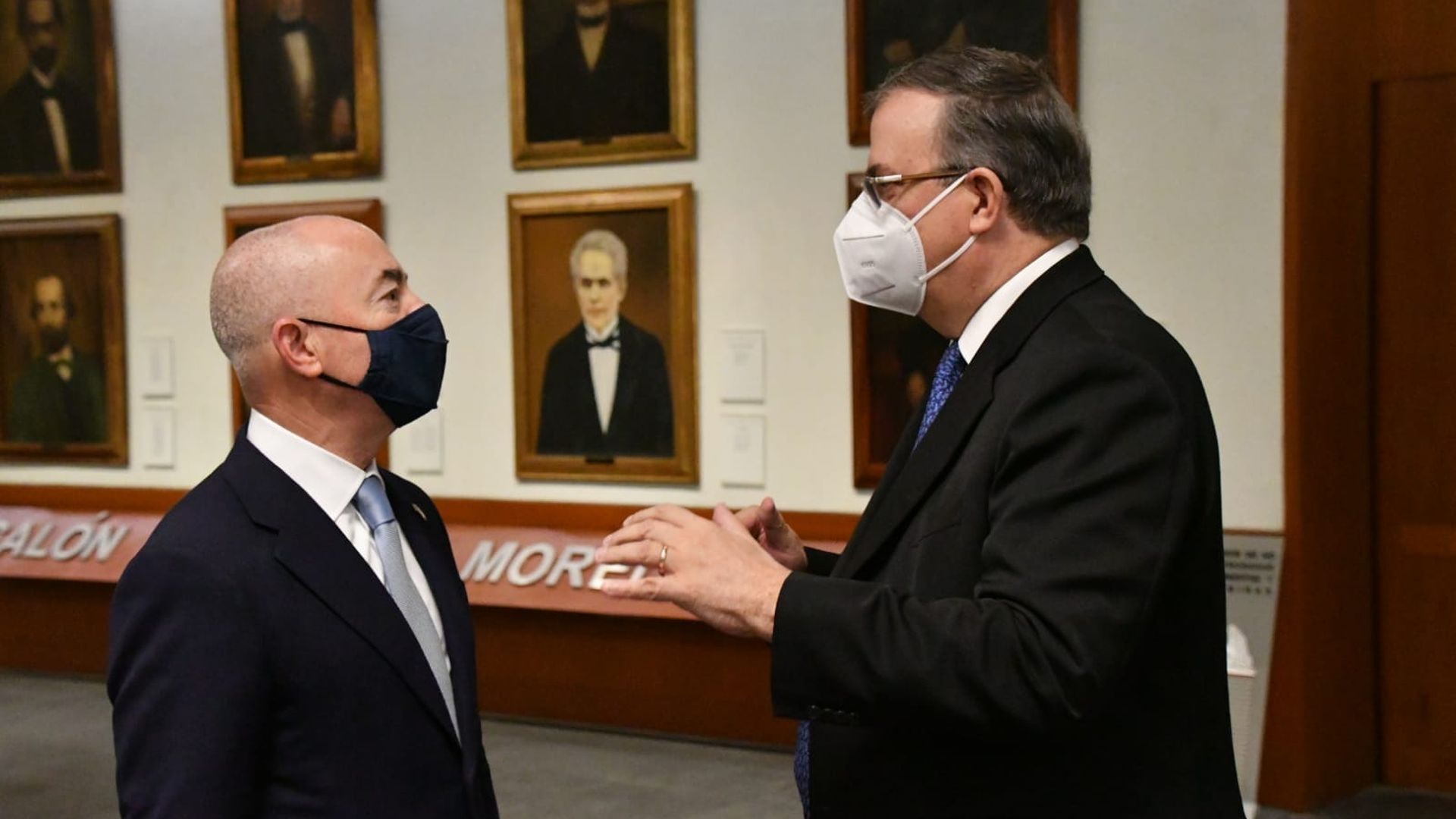 U.S. immigration chief Alejandro Mayorkas (L) talks with Mexican Foreign Affairs minister Marcelo Ebrard. 