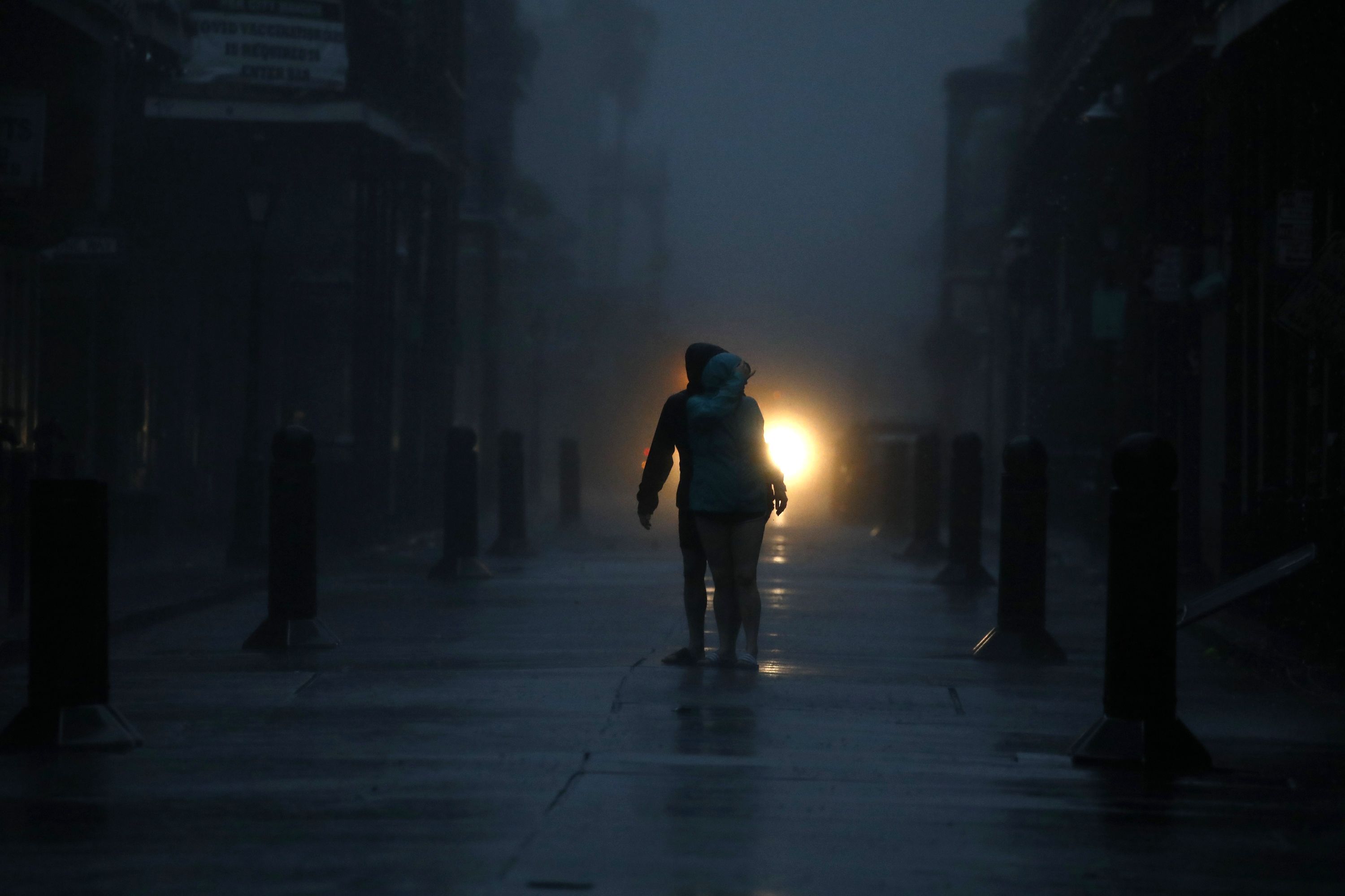 Pedestrians on Bourbon Street during a city-wide power outage caused by Hurricane Ida in New Orleans, Louisiana, U.S., on Sunday, Aug. 29