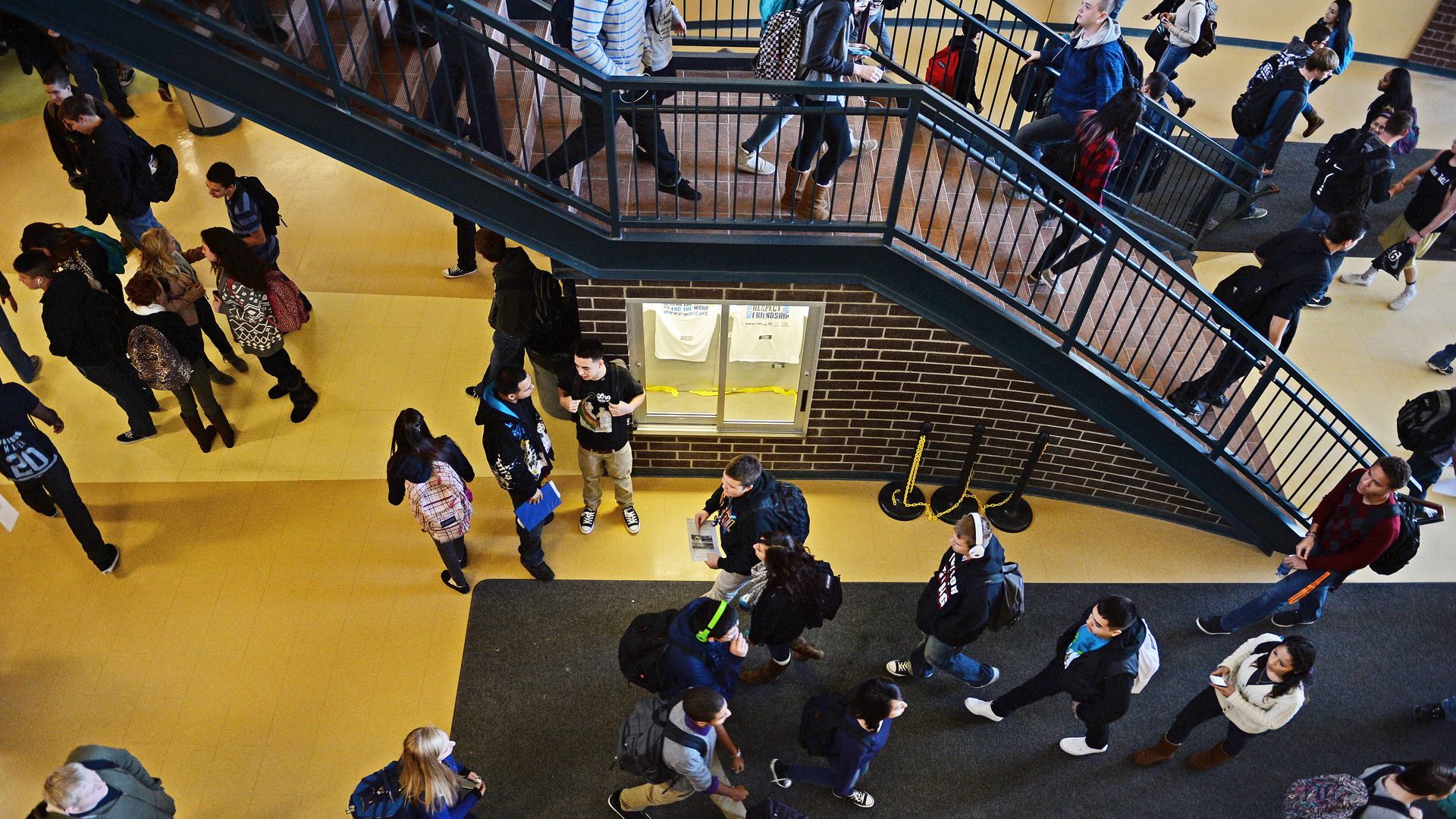 High schoolers walking in the hallway of their school