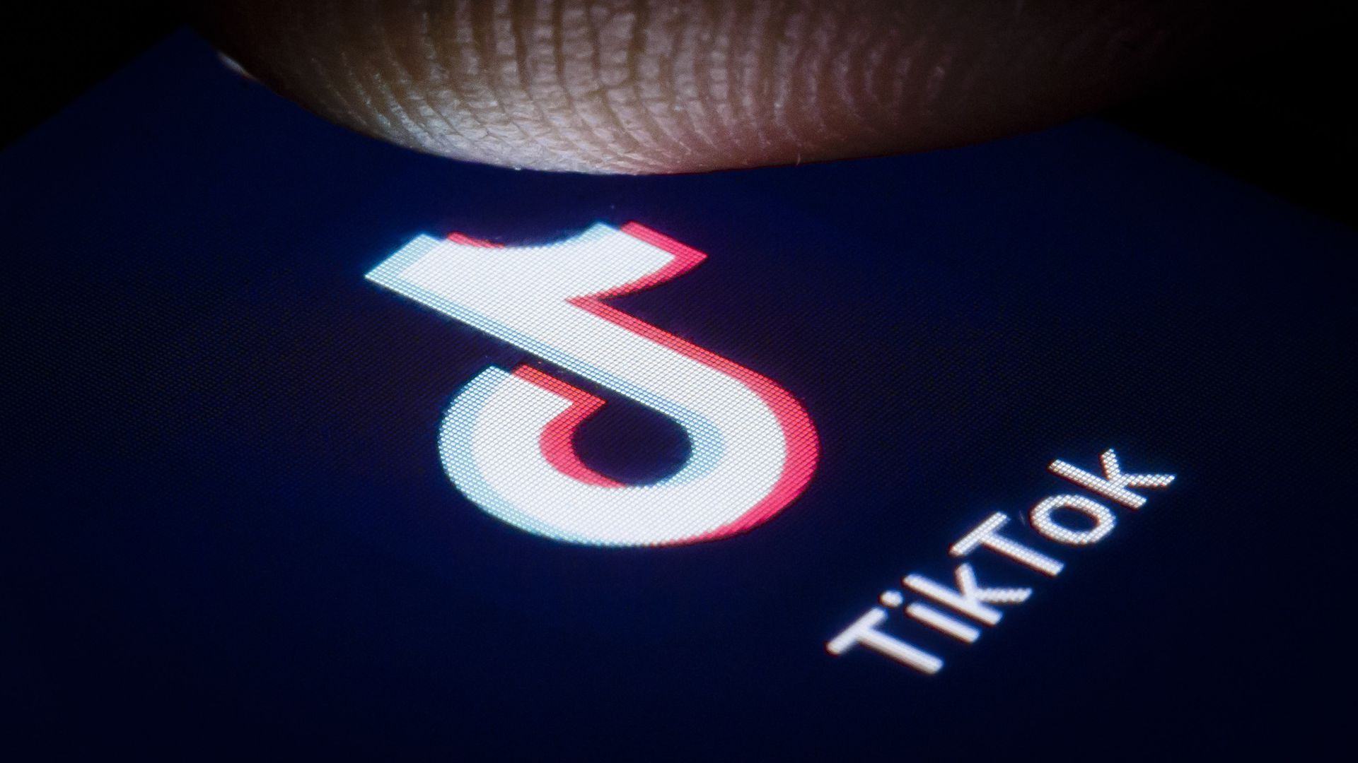 A finger above a smartphone icon for TikTok