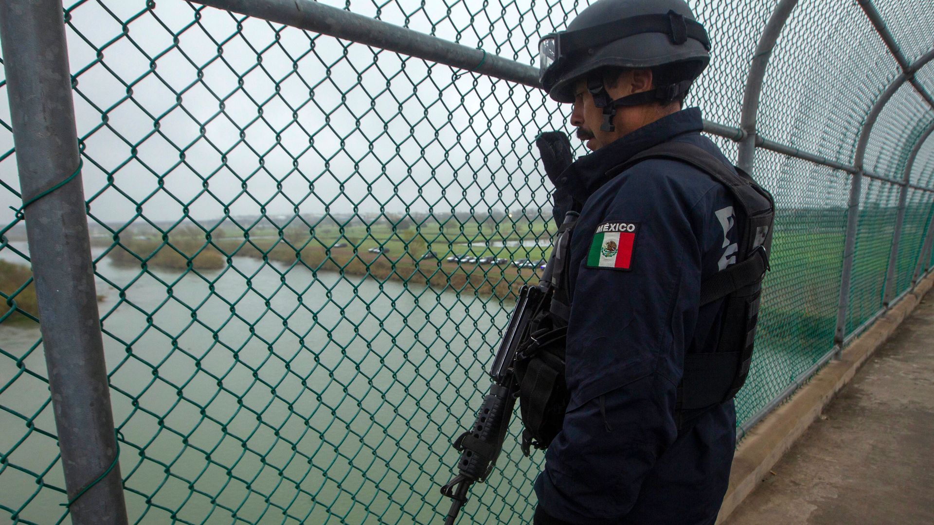 A Mexican Federal Police officer guards an international bridge between Mexico and Texas