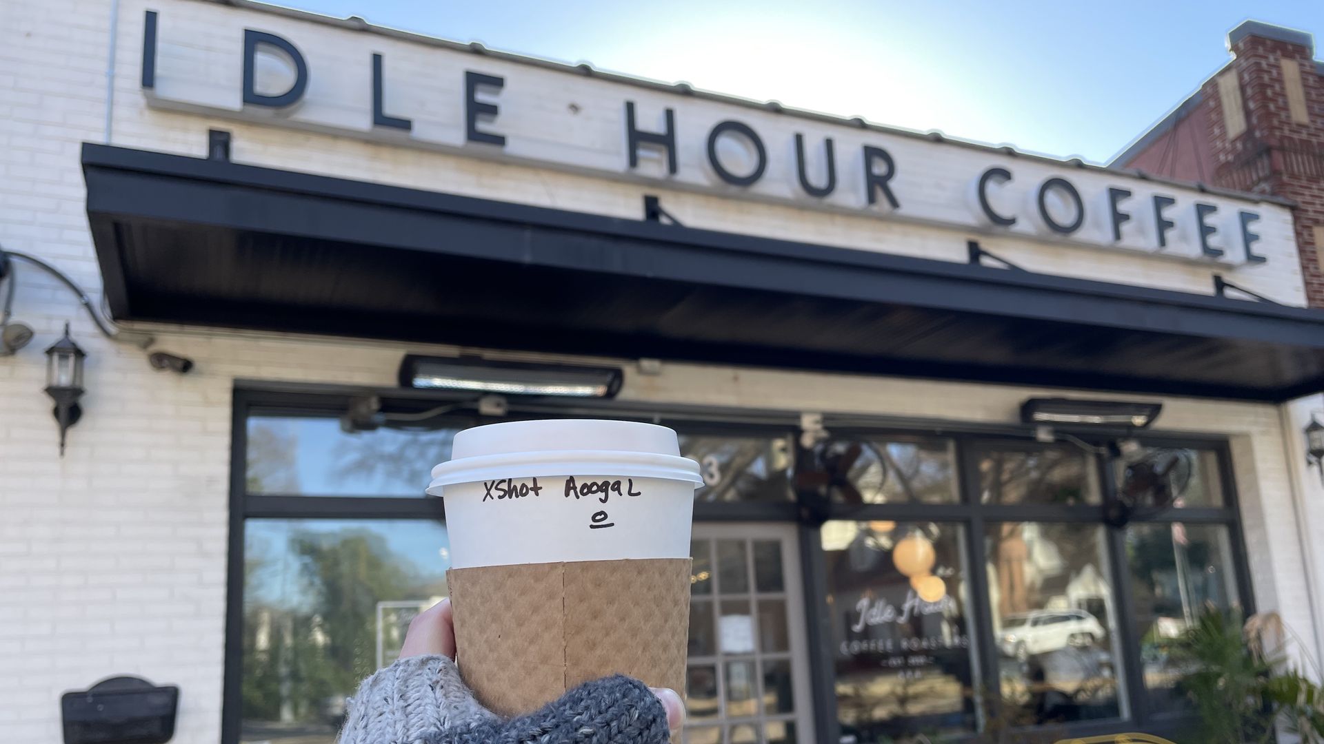 A coffee, in front of Idle Hour Coffee. 