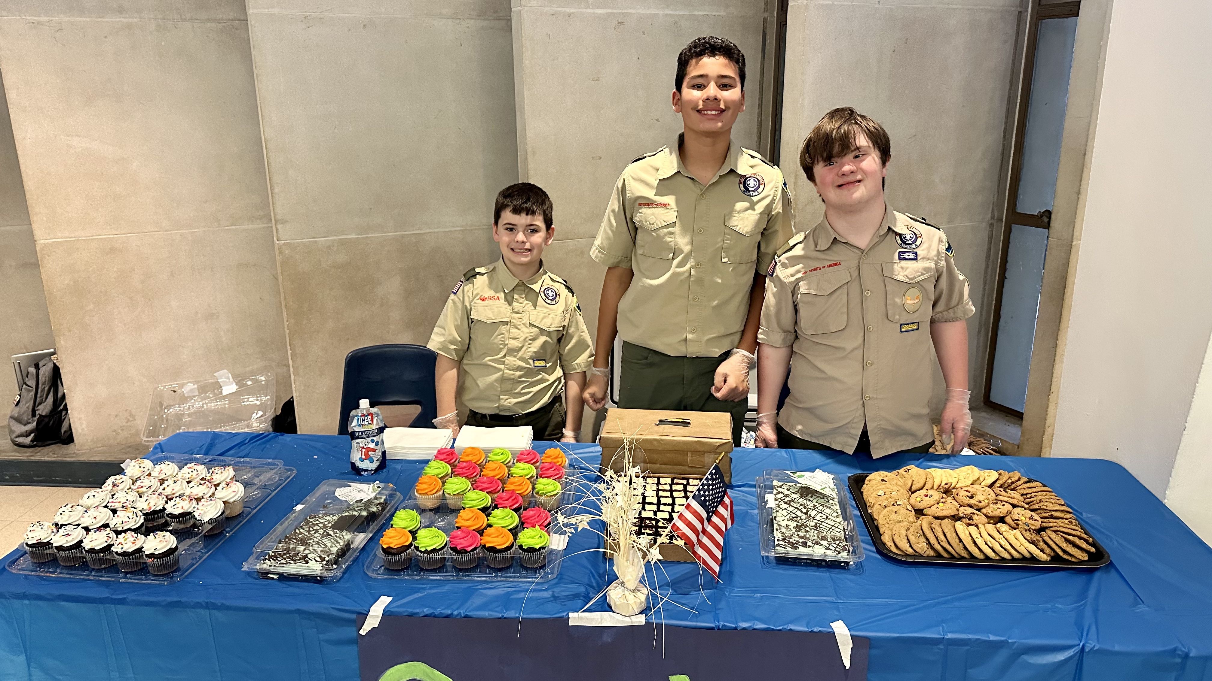 Photo shows the Boy Scouts manning the dessert table at St. Pius.