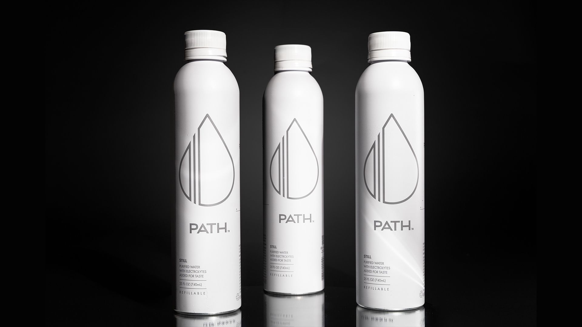 Three white aluminum bottles of Path water on a black background.