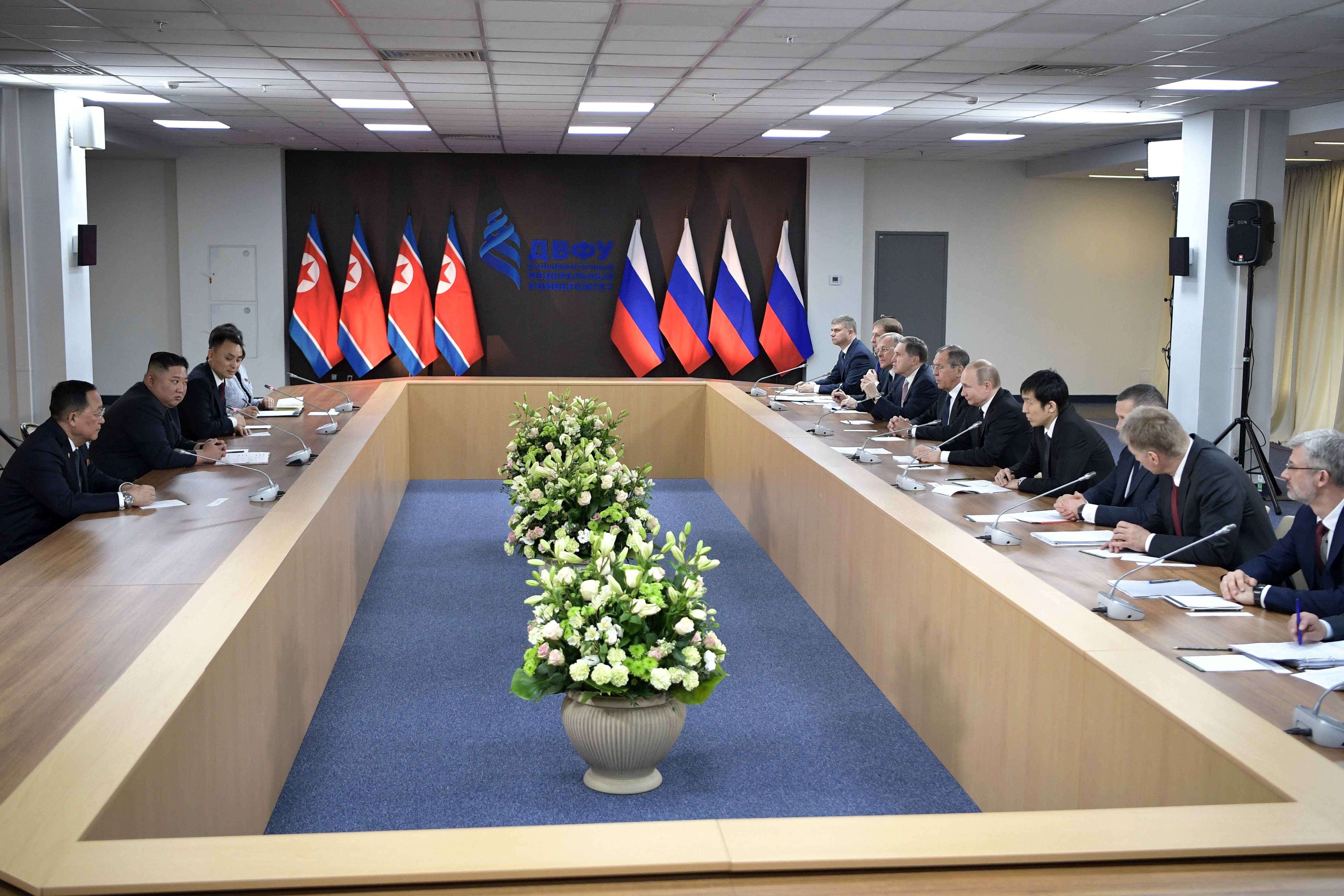 Russian President Vladimir Putin, North Korean leader Kim Jong Un and members of the delegations hold talks at the Far Eastern Federal University campus on Russky island.