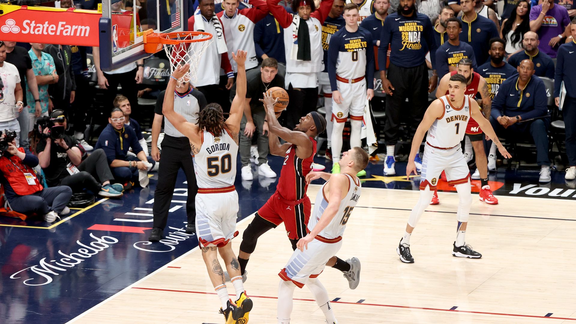 Jimmy Butler drives over two defenders.