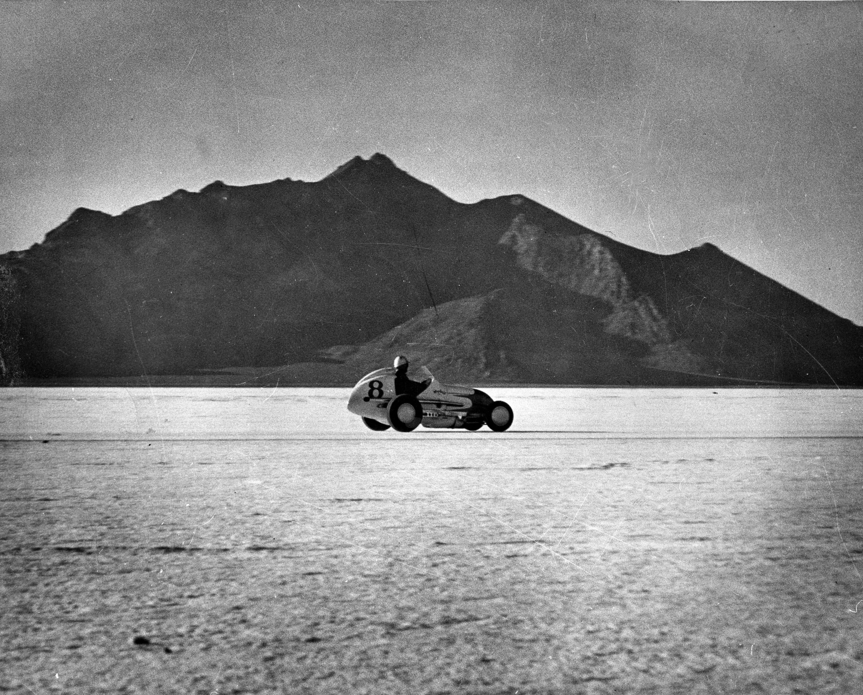 Rex Mays drives an Offenhauser-powered Midget racecar to a speed record near a mountain on the Bonneville Salt Flats in 1949, just months before his death in California.