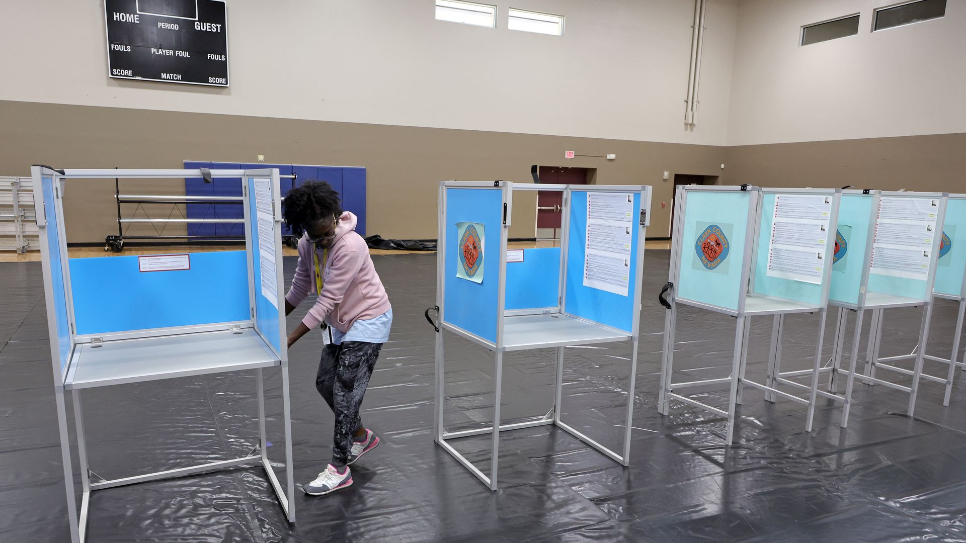 A Clark County Election Department worker sets up voting machine booths.