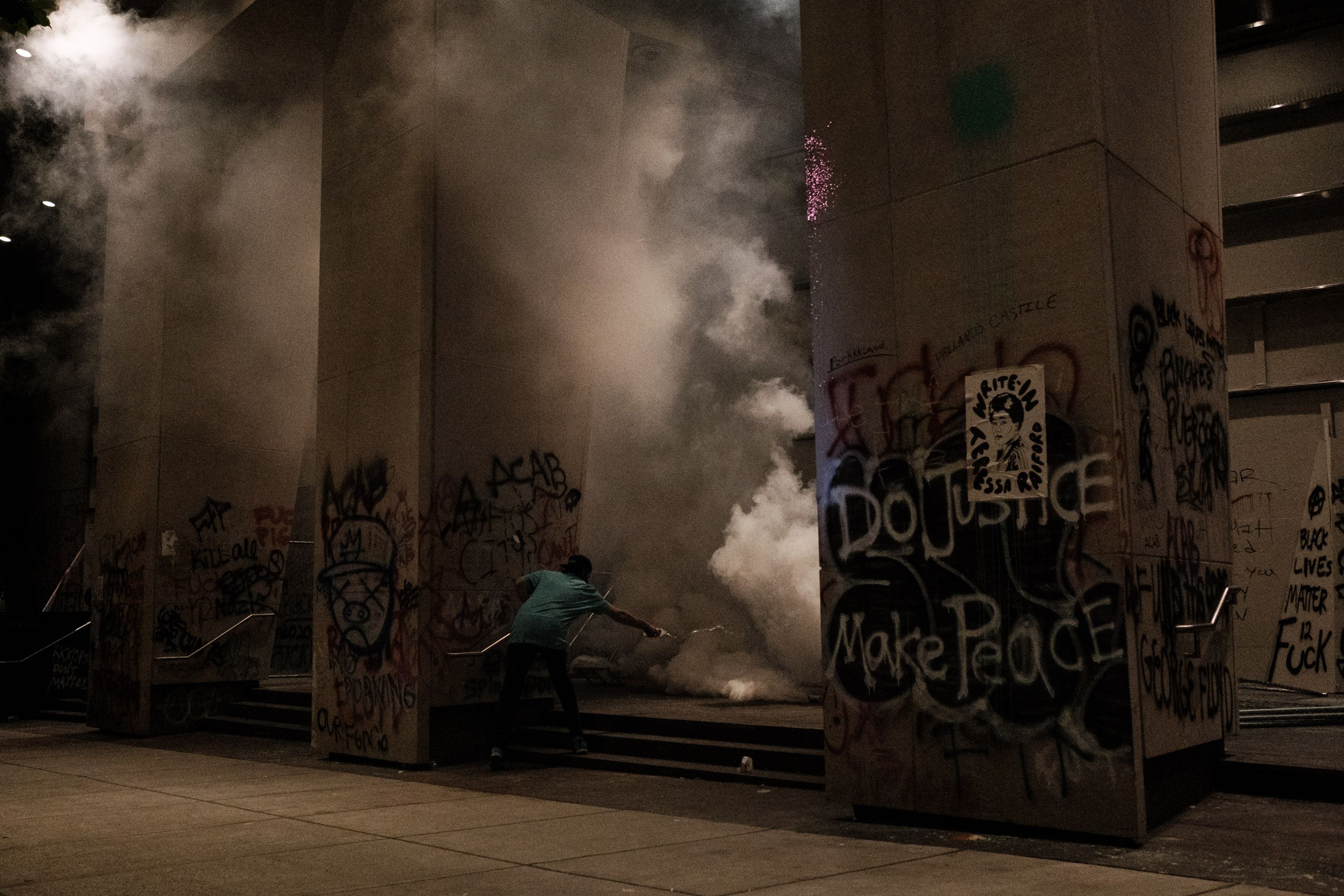 Tear gas being deployed on the steps of the U.S. District Court building. Photo: Mason Trinca/Getty Images