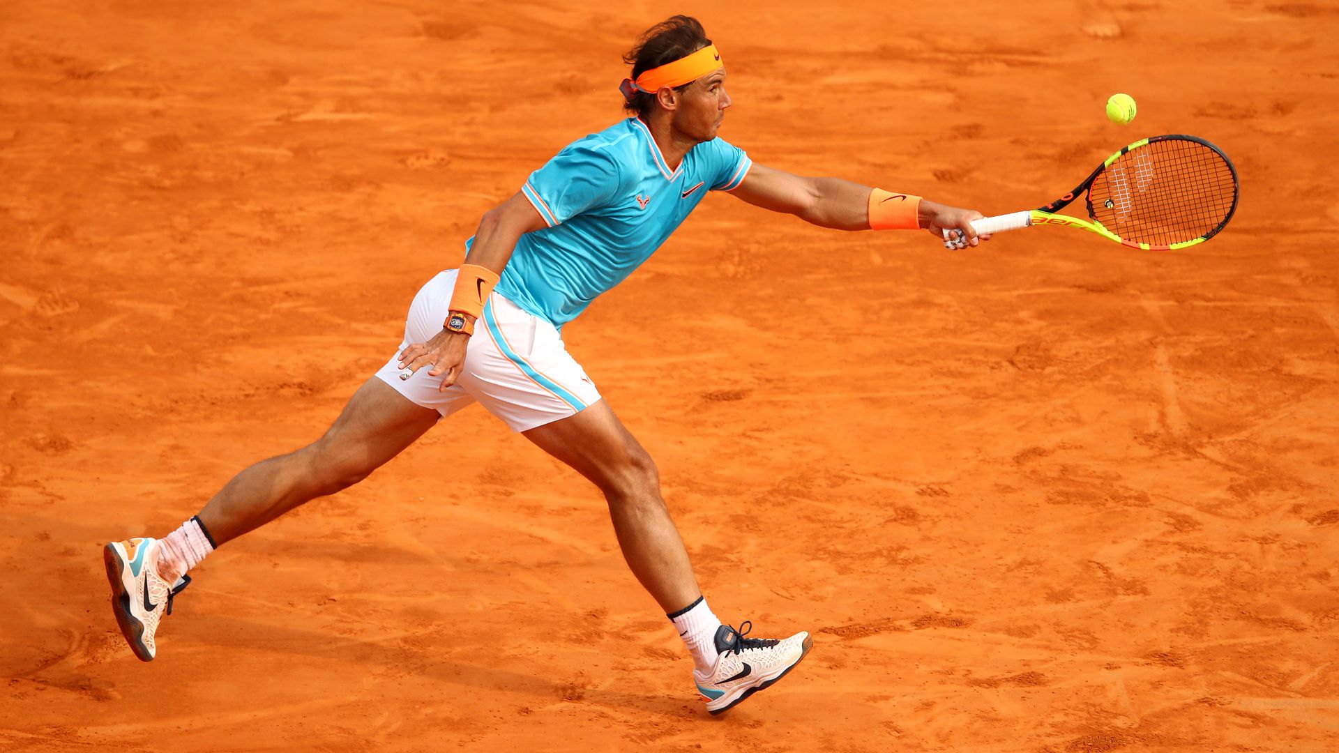 Rafael Nadal reaches to hit a ball