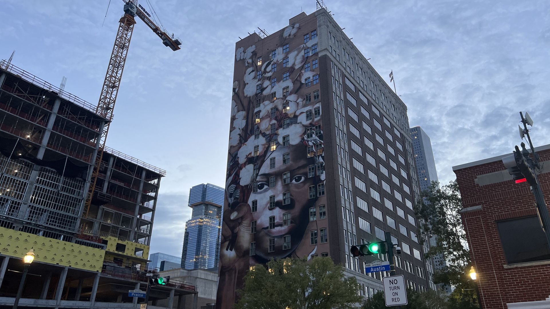 A mural of abolitionist Harriet Tubman on a tall building in downtown Houston
