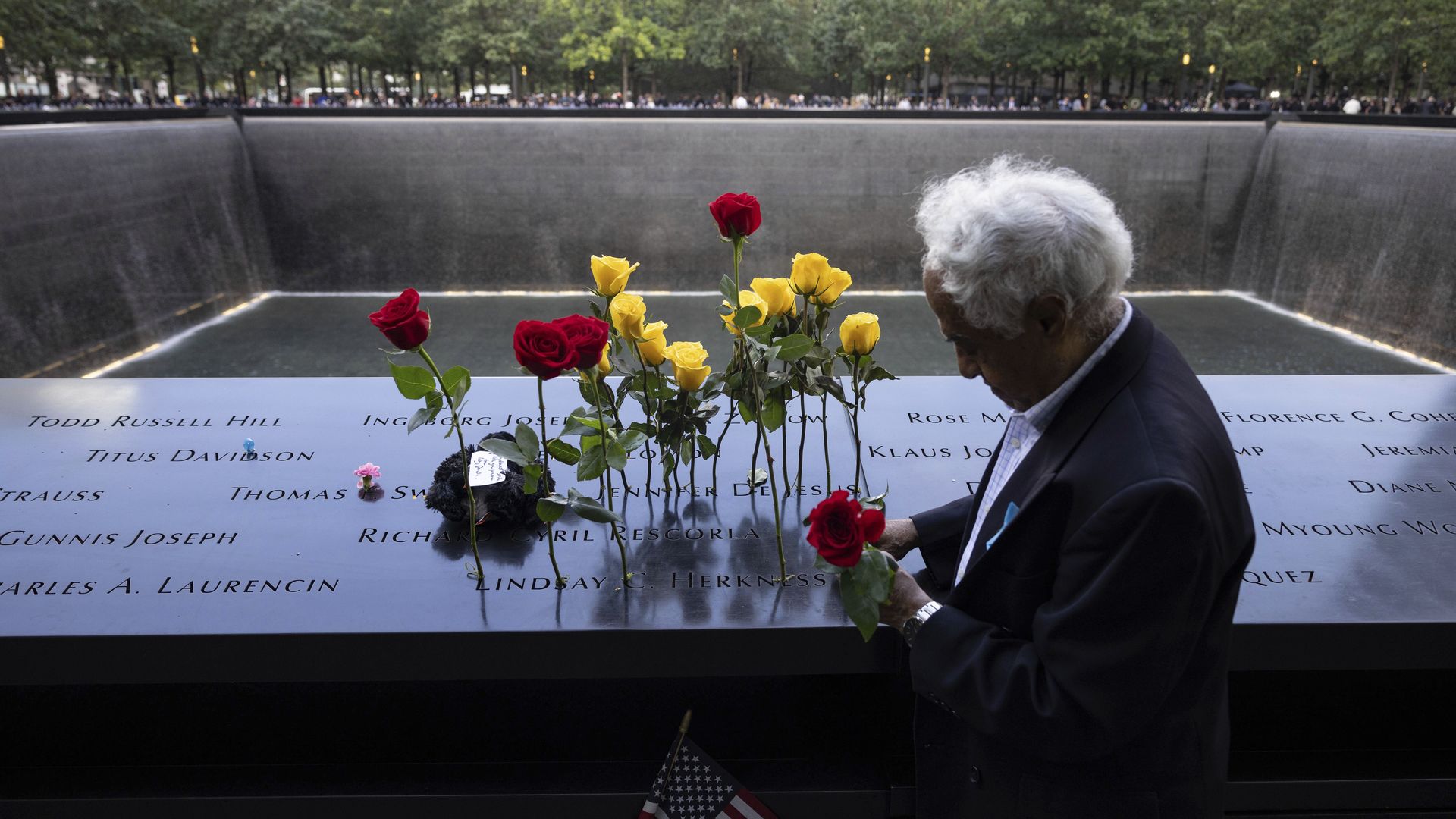 A man puts flowers on the 9/11 Memorial in Manhattan last year during a ceremony on the 21st anniversary of the terrorist attacks.