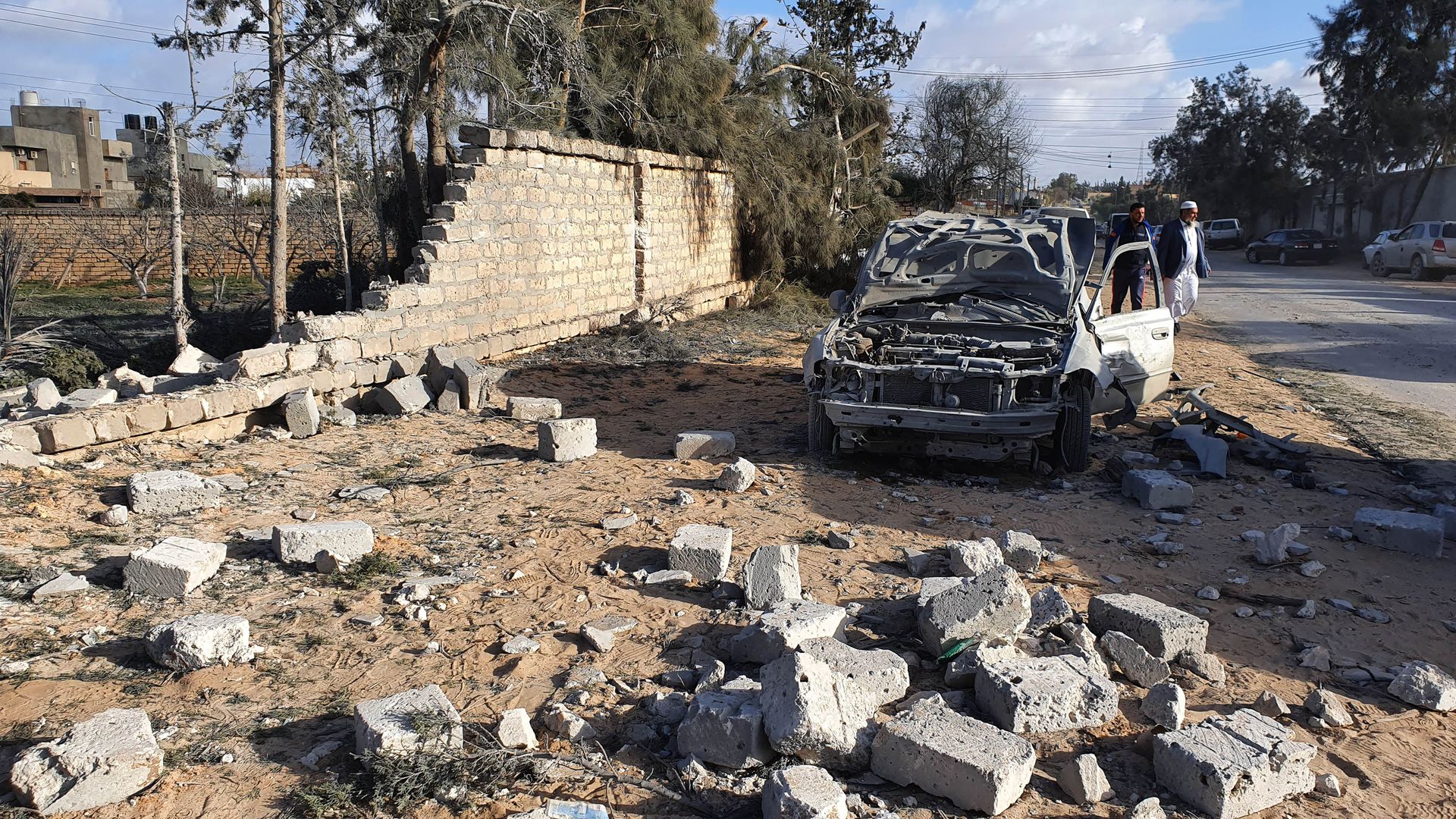 Debris and damaged cars in Tripoli