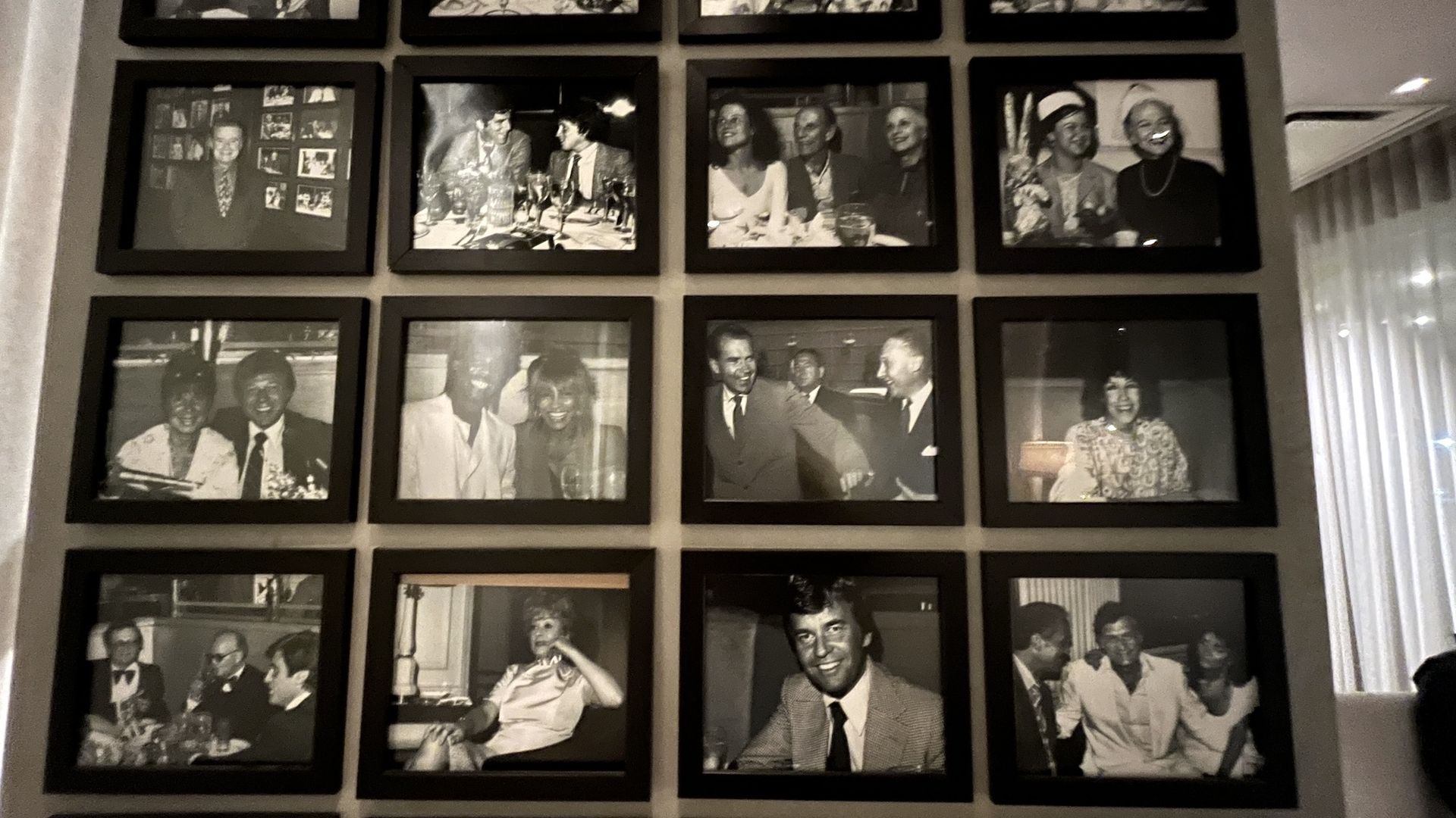 wall of black and white photos of celebrities