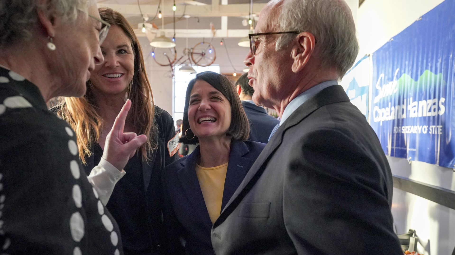 Photo of Becca Balint in conversation with three other people