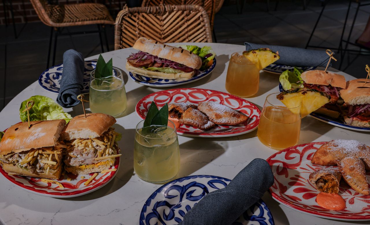 A variety of Peruvian sandwiches and cocktails on a table