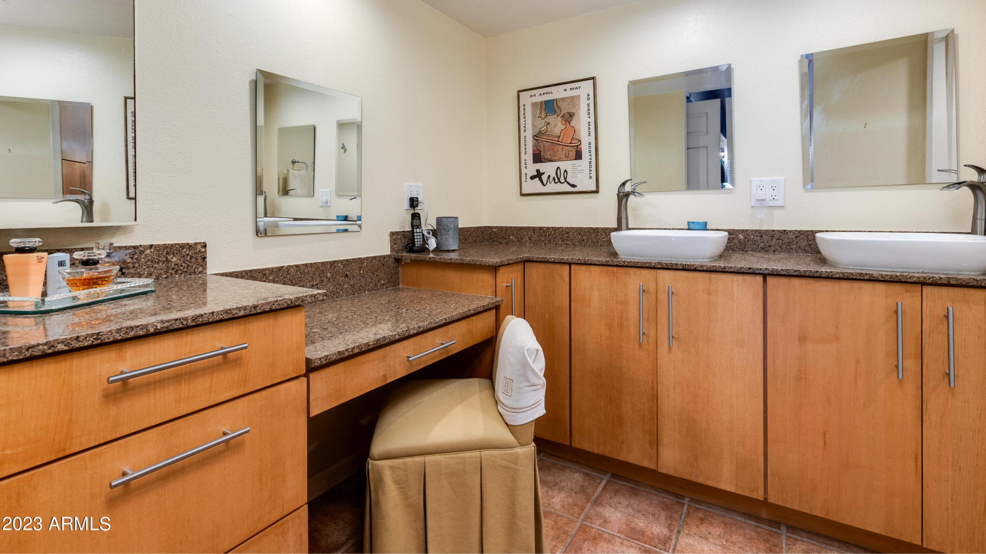 A bathroom with a vanity and double sinks.